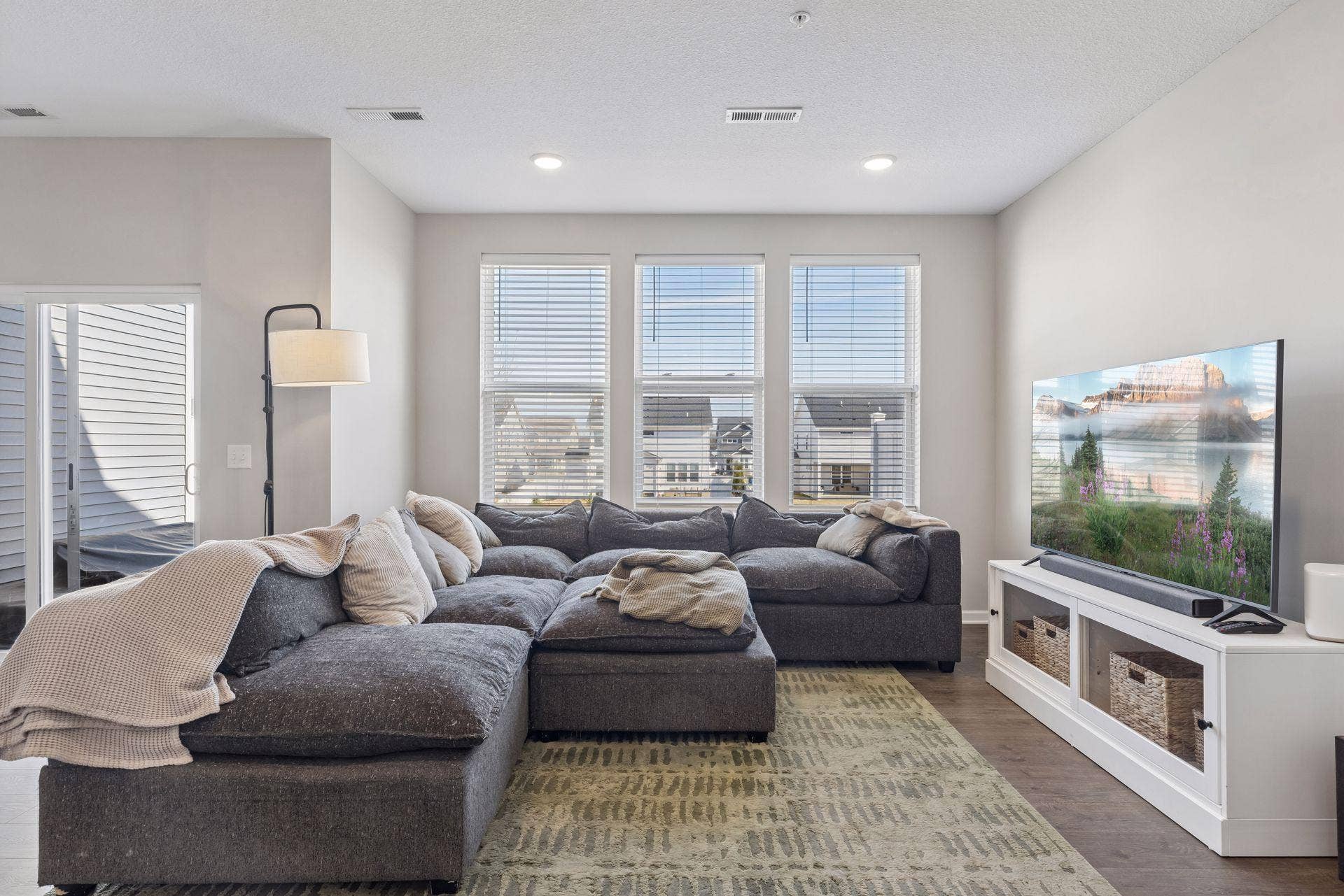 Living room featuring recessed lighting and large windows providing abundant natural light.