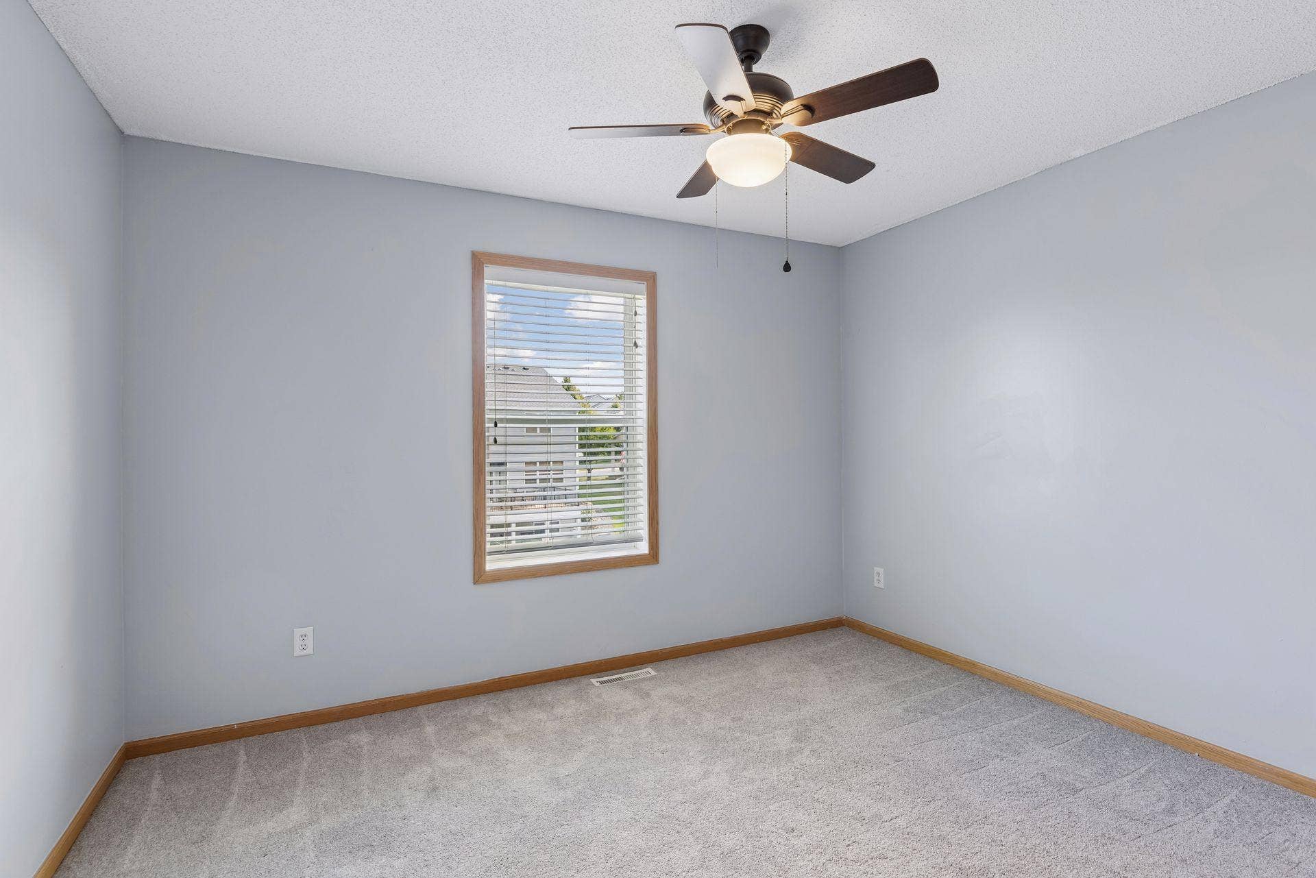 Additional upper level bedroom with ceiling fan.