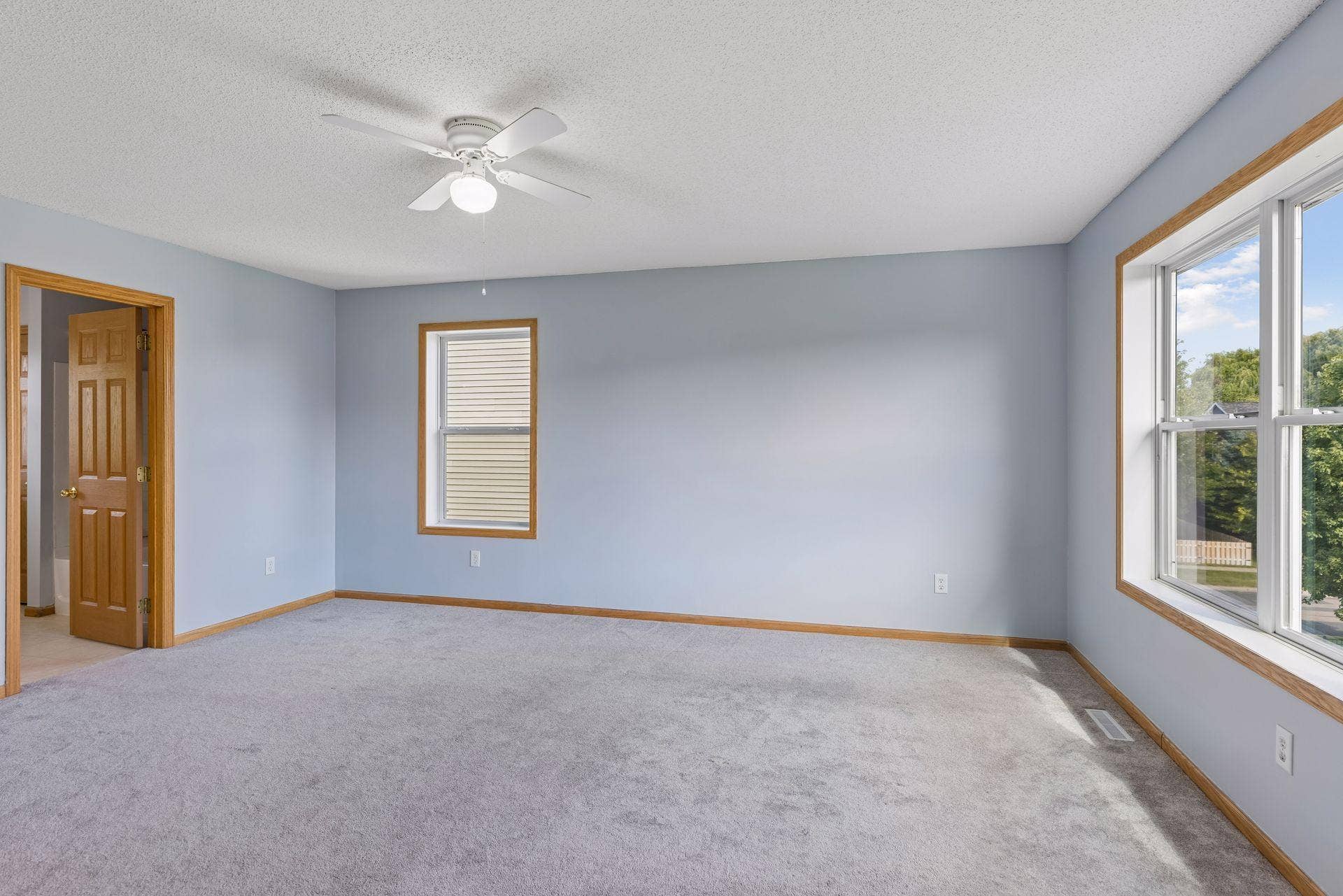 Spacious primary bedroom with abundant natural light