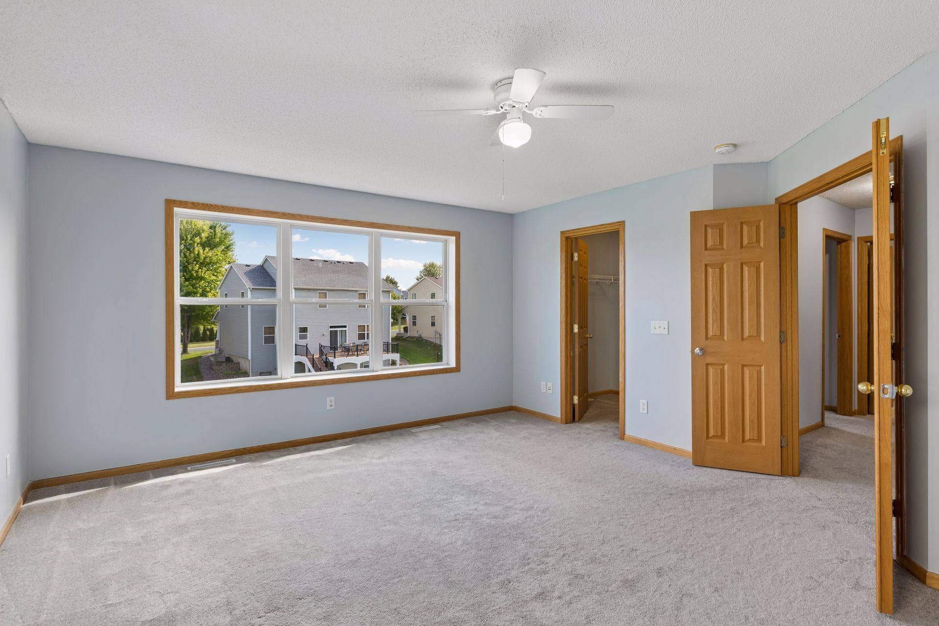 Spacious primary bedroom with abundant natural light.