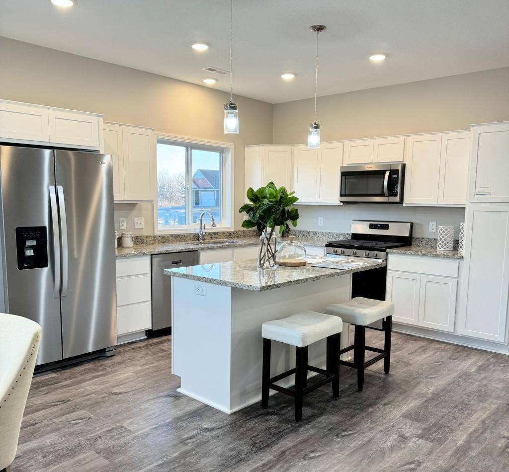 4907 Evergreen Drive N, Hugo, MN 55038 Open floor plan with great natural light, quartz countertops and stainless steel appliances. Photos from similar home.