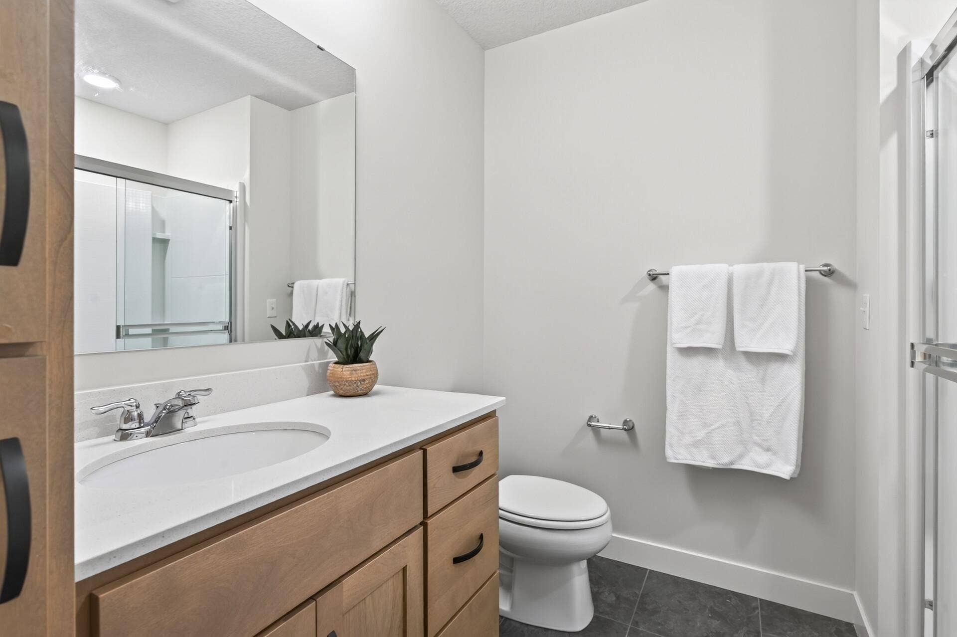 9960 Arrowwood Trail, Woodbury, MN 55129 With ample cabinetry space and a linen closet, this lower level 3/4 bathroom is perfect for entertaining guests or hosting an overnight stay, positioned right across from the 5th bedroom.