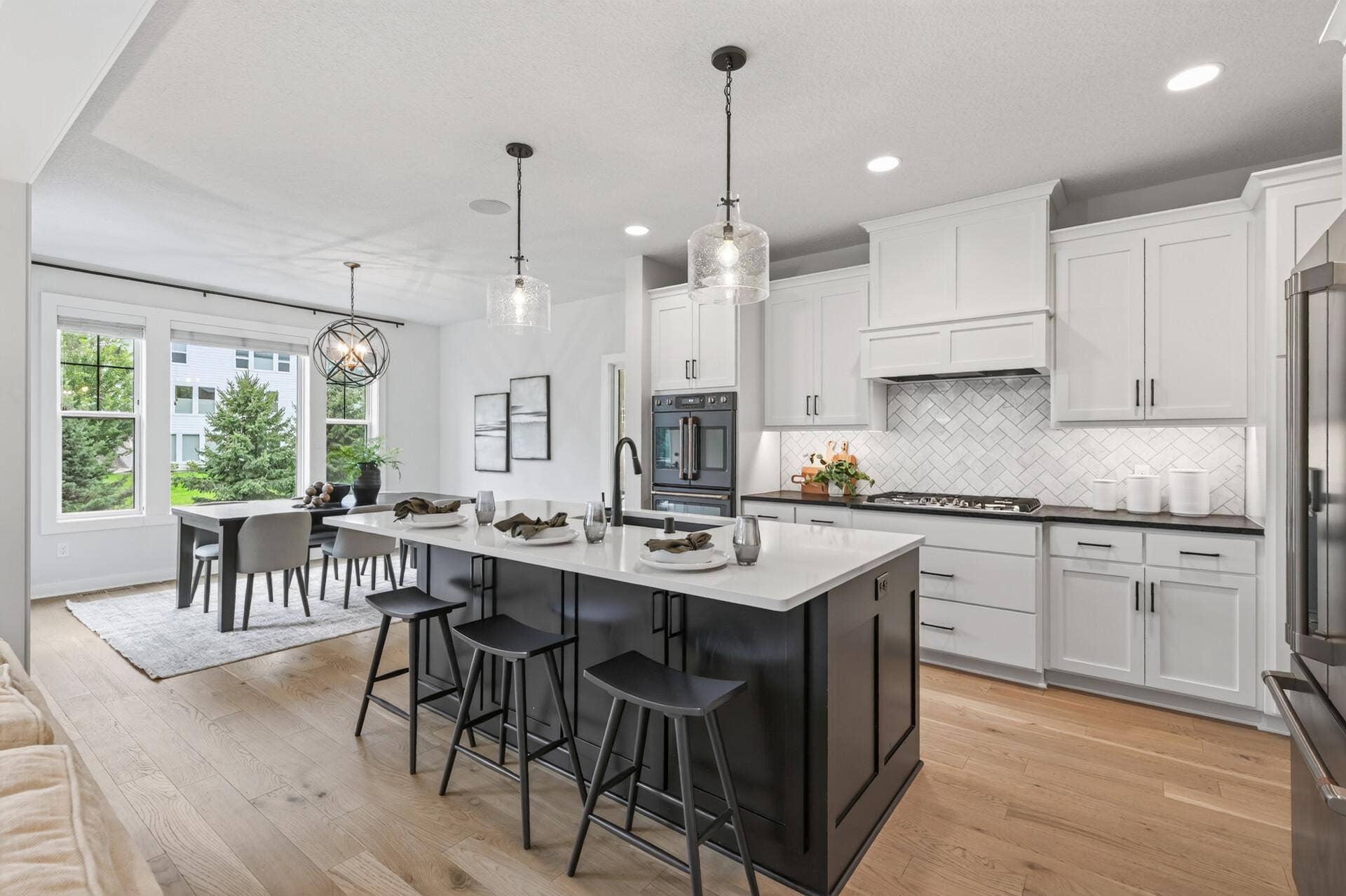 9960 Arrowwood Trail, Woodbury, MN 55129 A show-stopping kitchen with an open sightline to the dining room the heart of the home for gathering and entertaining.