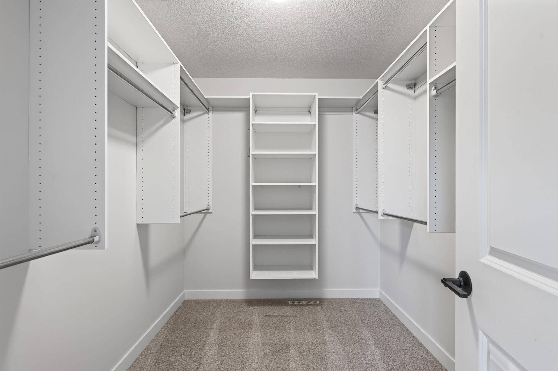 9960 Arrowwood Trail, Woodbury, MN 55129 Vacant view of this spacious owner's suite walk-in closet comes complete with an organized clothing system, making it easy to keep everything in its place.