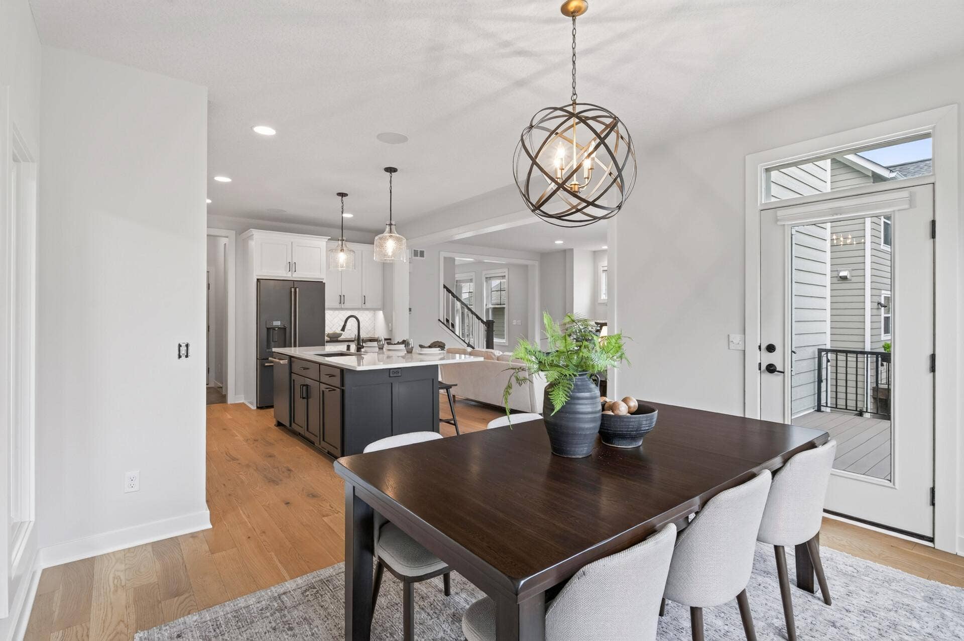 9960 Arrowwood Trail, Woodbury, MN 55129 From the dining room, enjoy an open sightline into the kitchen and living room, creating a seamless flow that's perfect for entertaining and everyday family life.