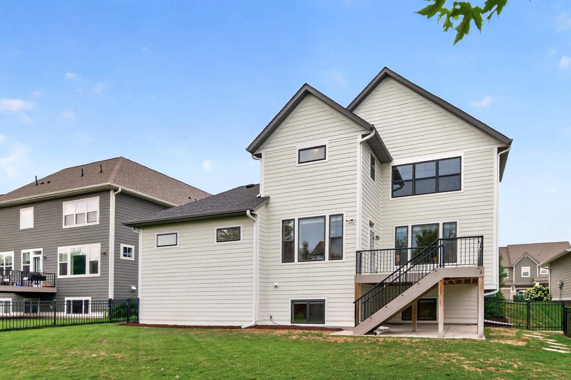 9960 Arrowwood Trail, Woodbury, MN 55129 Backyard exterior view of this stellar home!