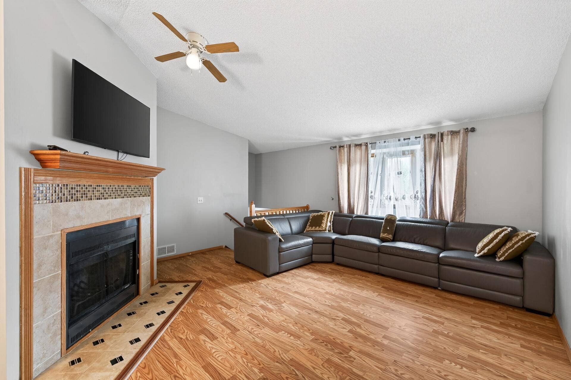 1124 Meadowwood Drive, Brooklyn Park, MN 55444 Upper living room with wood burning fireplace, bay window and vaulted ceilings