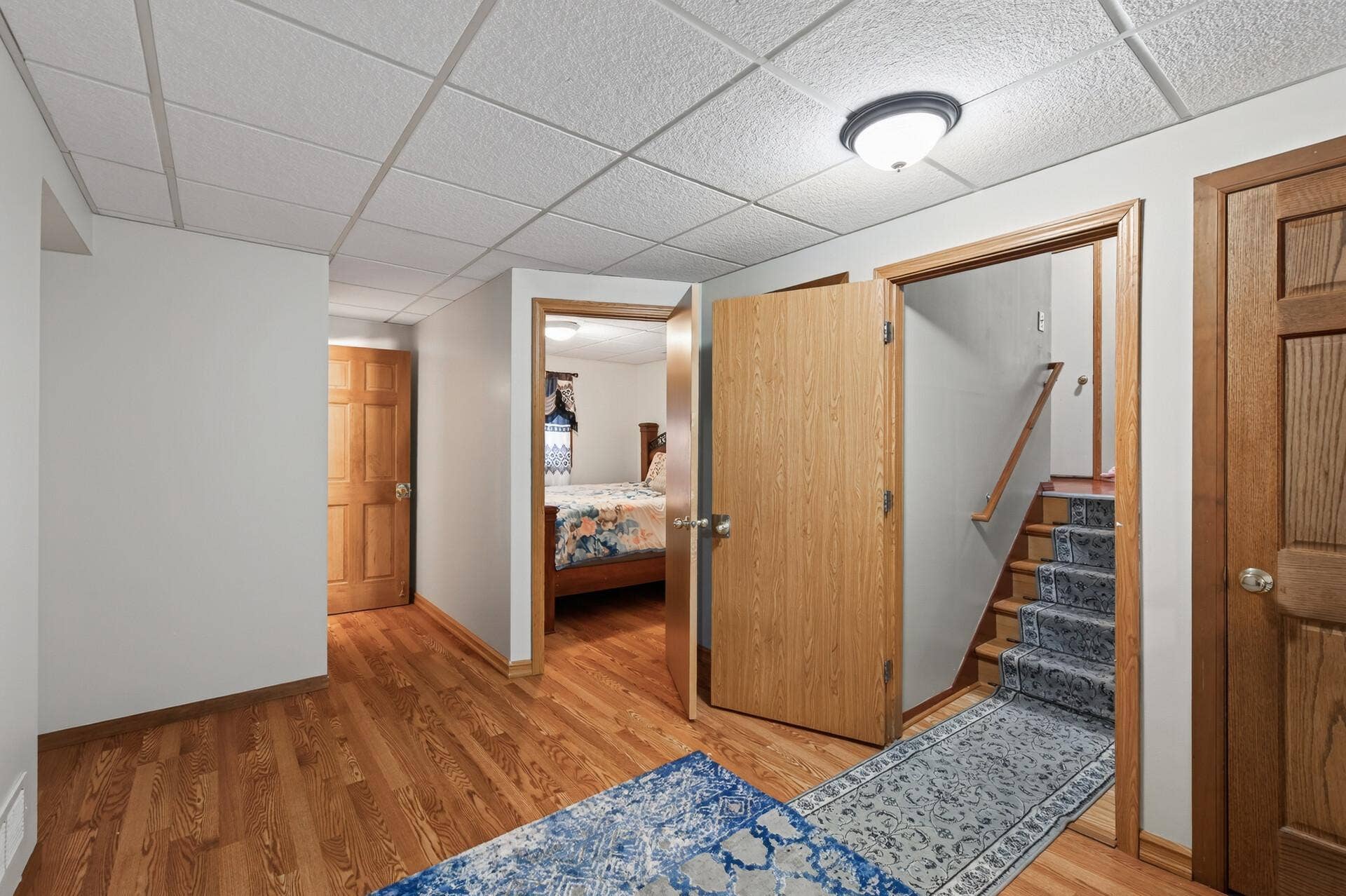 1124 Meadowwood Drive, Brooklyn Park, MN 55444 Open lower level with storage closets on either side of the stairs.