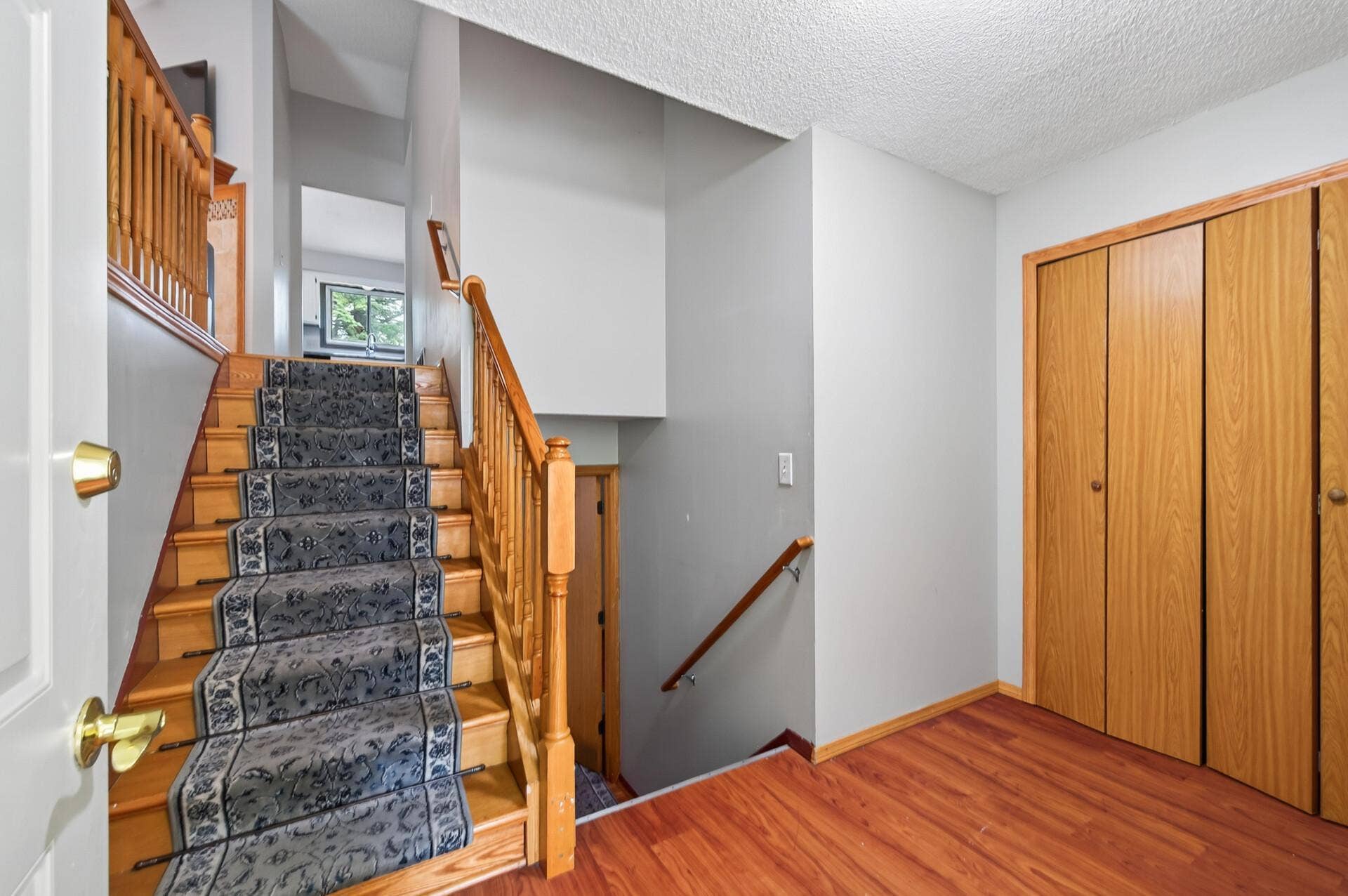 1124 Meadowwood Drive, Brooklyn Park, MN 55444 Landing with access to upper and lower floors, coat closet and attached garage access.