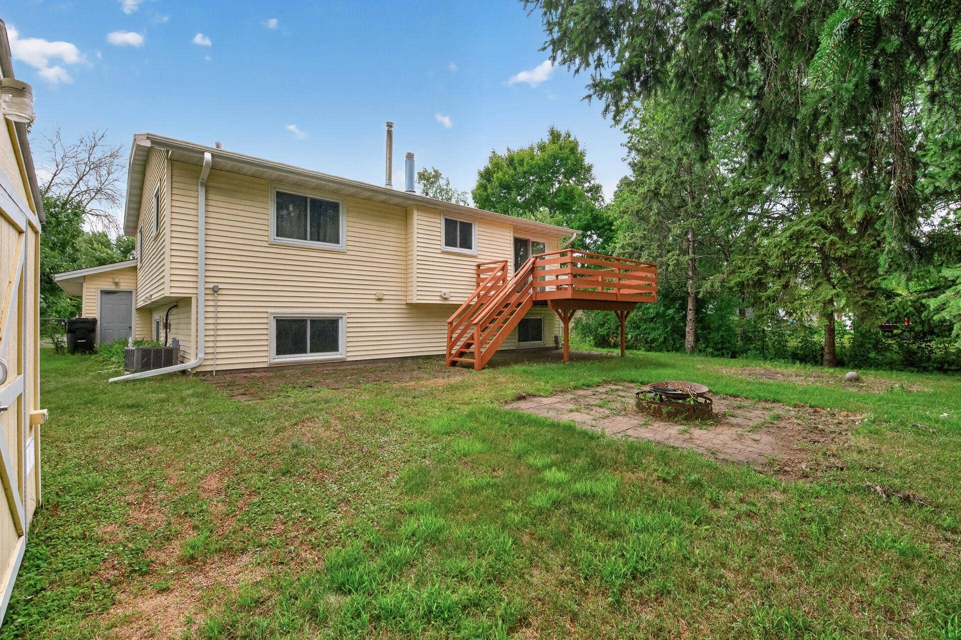1124 Meadowwood Drive, Brooklyn Park, MN 55444 Rear yard has mature trees, patio areas and deck