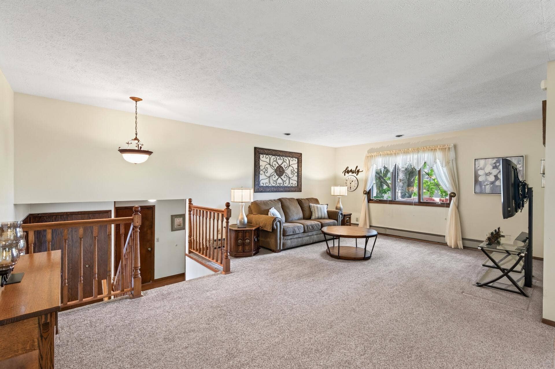 3800 101st Avenue N, Brooklyn Park, MN 55443 Spacious living room with wood railing on the stairway.