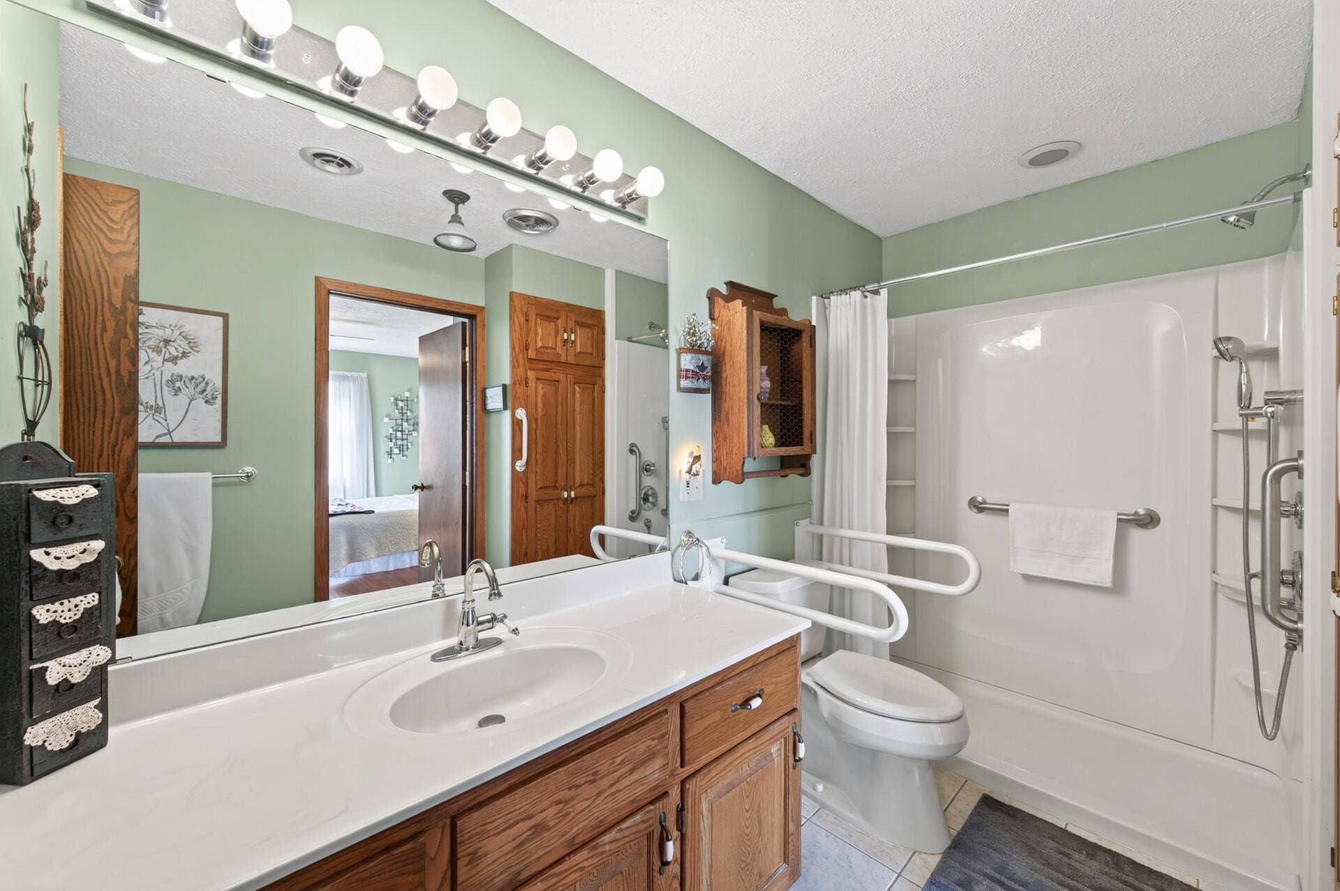 3800 101st Avenue N, Brooklyn Park, MN 55443 The upper level bathroom has been remodeled and updated. Low threshold shower with grab bars, hand shower and recessed light.