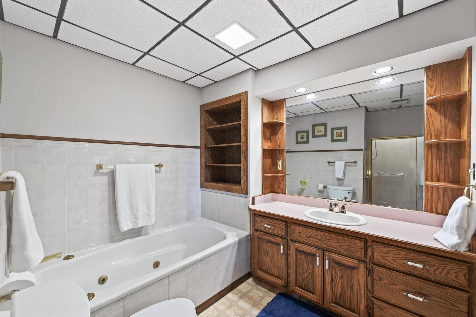 3800 101st Avenue N, Brooklyn Park, MN 55443 Fantastic lower level full bath with a jacuzzi tub, separate shower and large vanity with built ins.