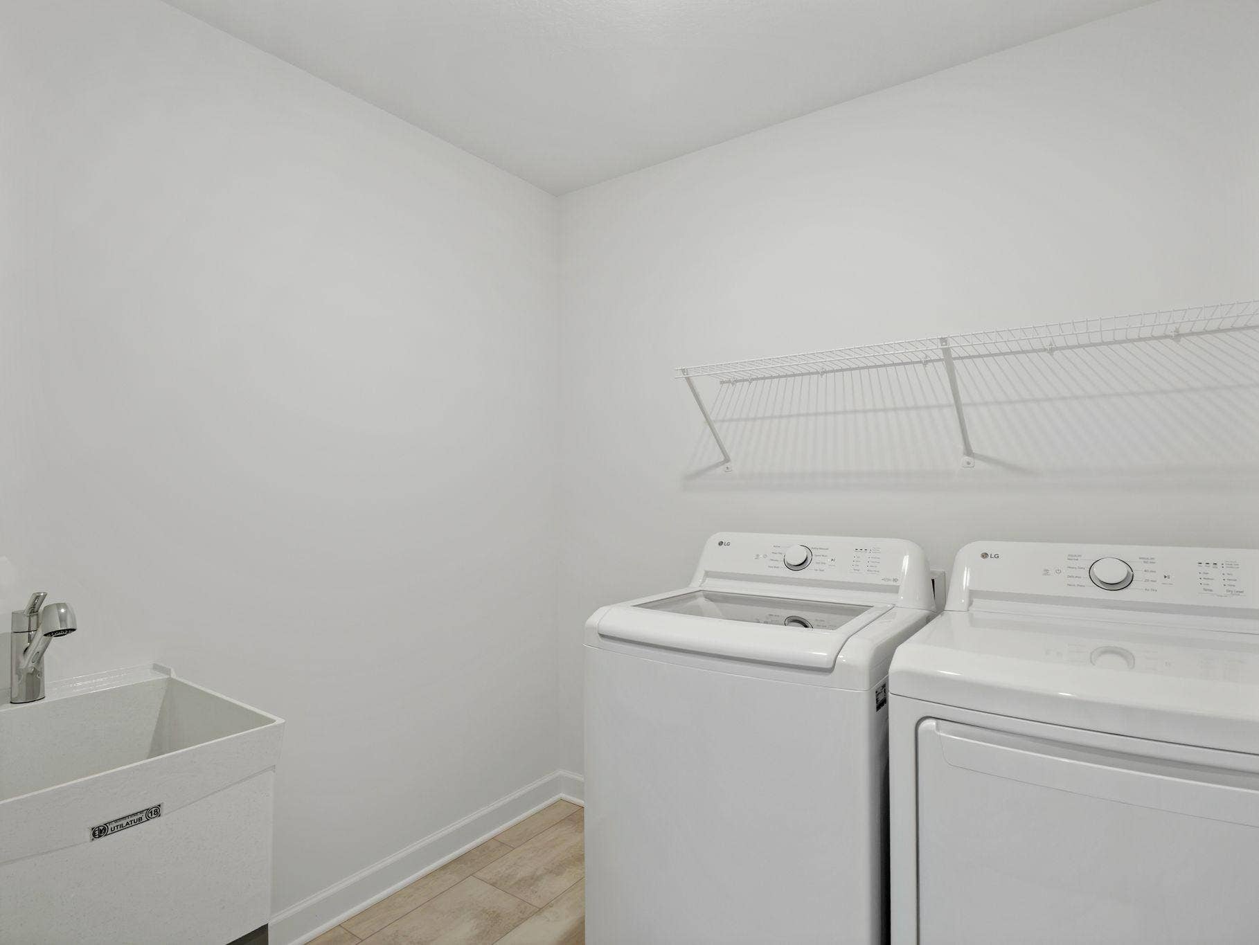 There is plenty of space on the second-floor laundry room for a new washer and dryer. Shown here with an optional rinse sink.