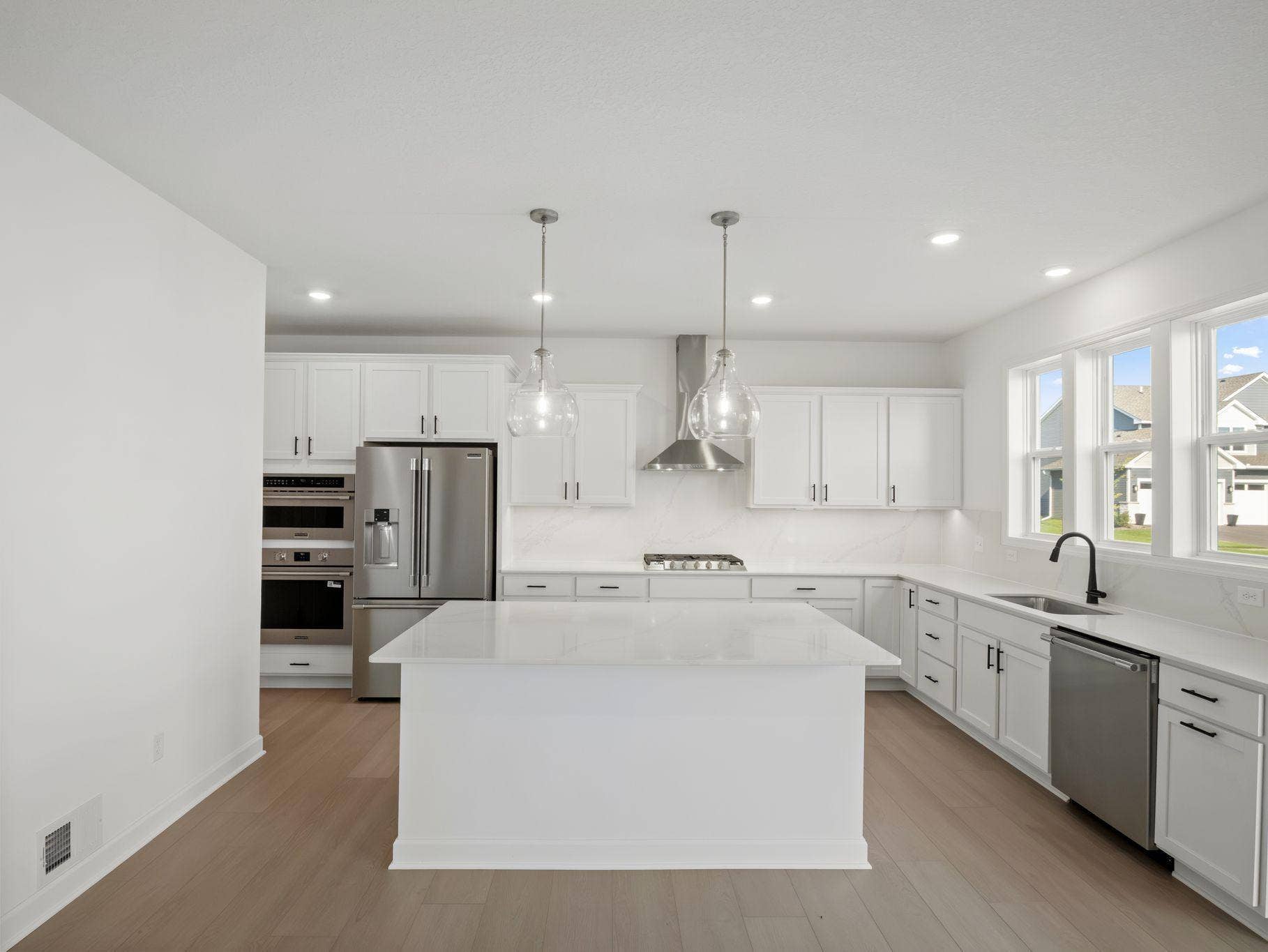 The center island extends out to a breakfast bar for casual meals