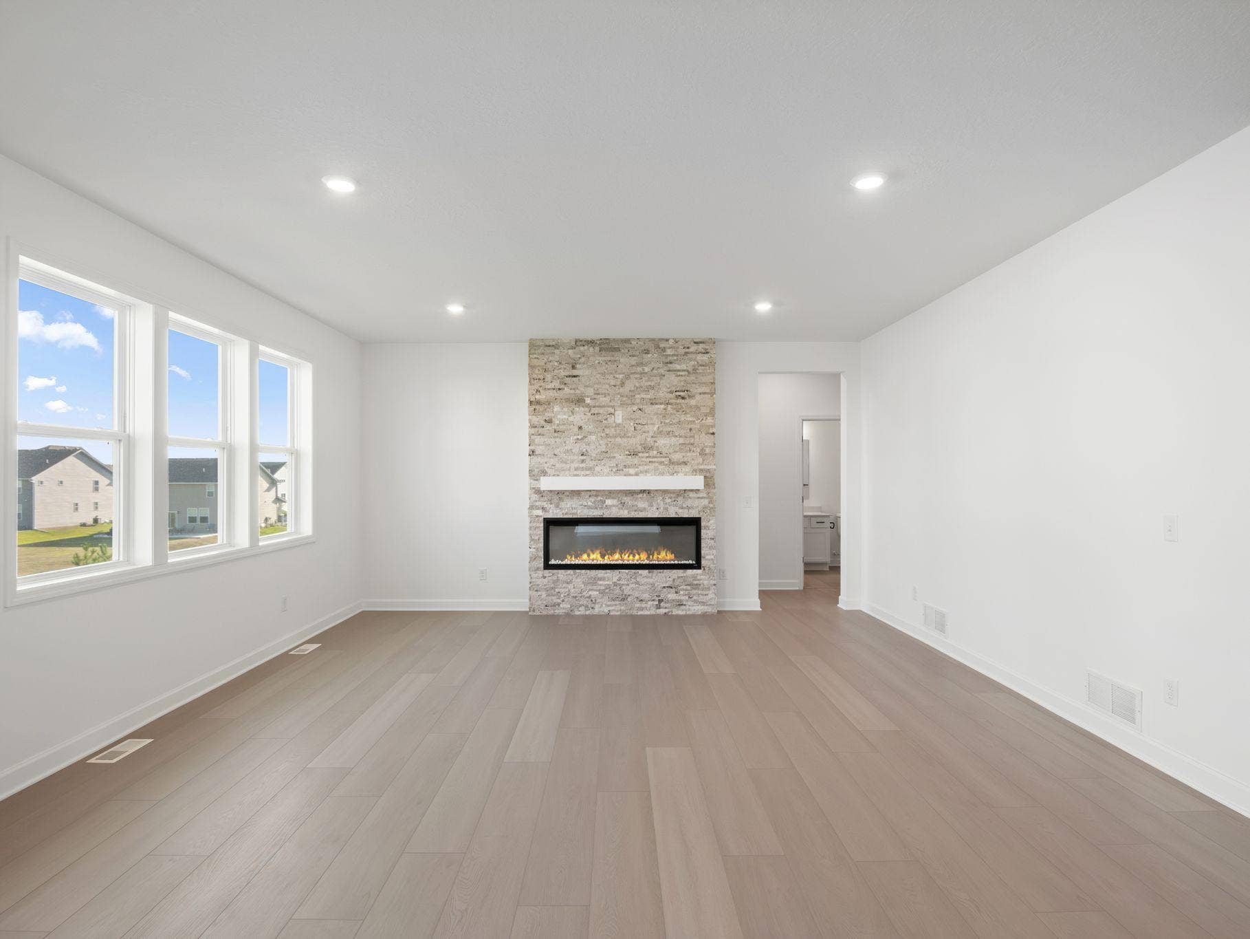 Enjoy shared moments with loved ones in the comfortable and spacious Great Room, where expansive windows flood the space with natural light.
