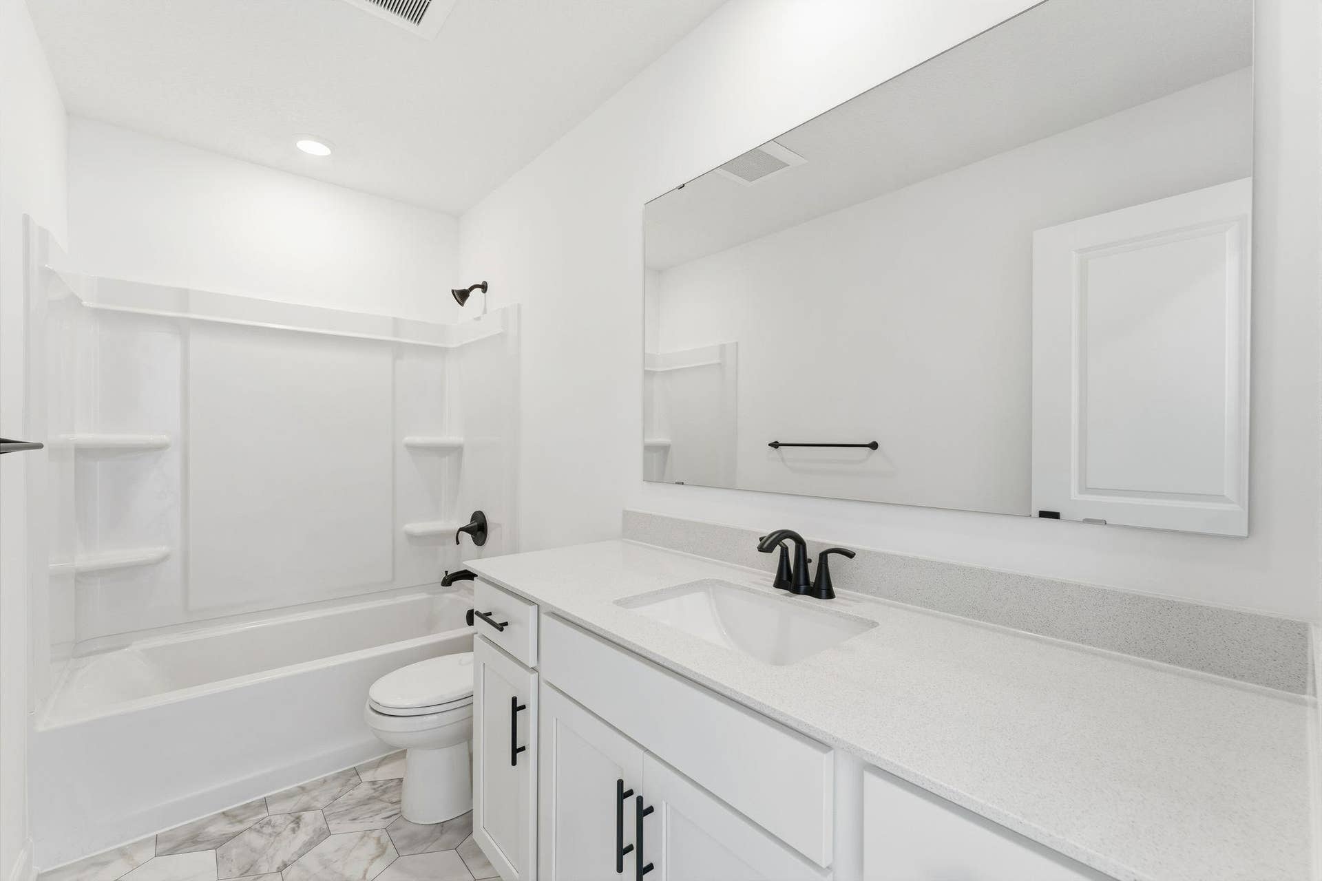 10551 Harbor Lane N, Maple Grove, MN 55369 (Photo of a similar home, actual finishes may vary) A full-sized bathroom on the second floor comes well-equipped with a generously sized quartz-topped vanity and a combination shower and tub to maximize the interior space.