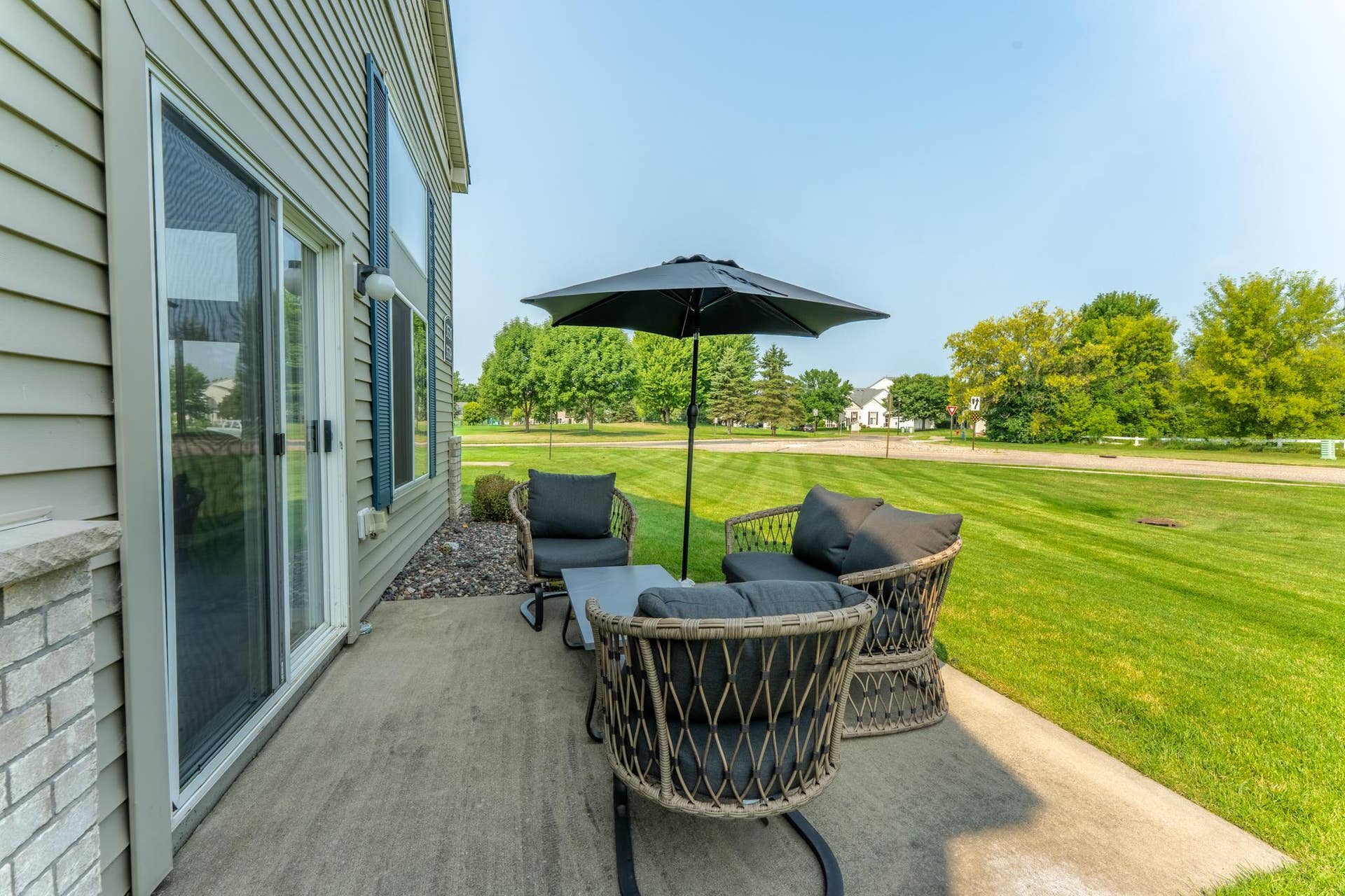 Patio with green space around it.