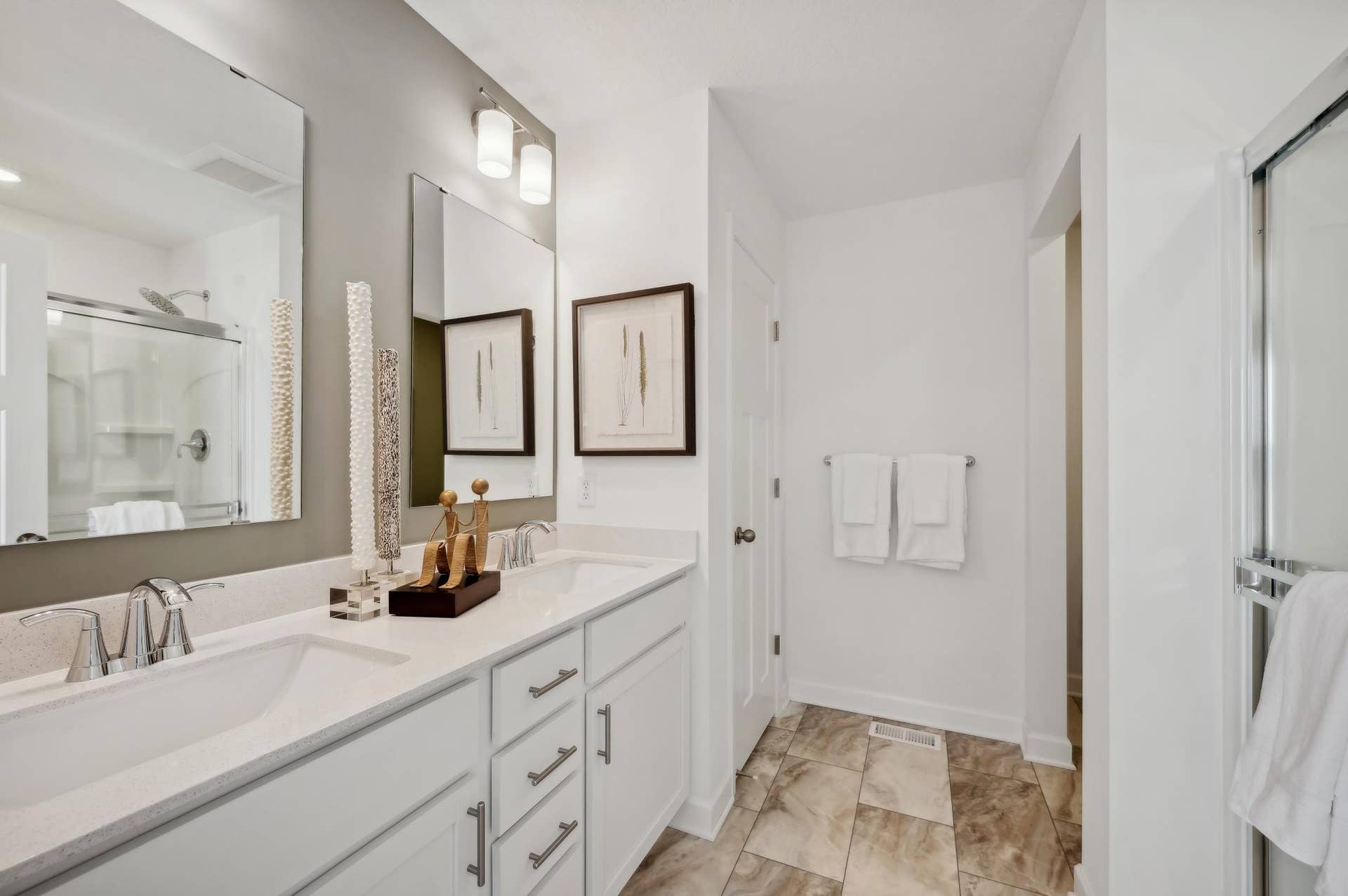 (Photo of model home, finishes will vary) An extension of the owner's suite, this private and spacious bath contains a double-vanity, a separate shower, and a walk-in closet.