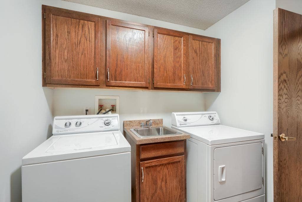 9600 Portland Avenue S, #317, Bloomington, MN 55420 In unit laundry room with lots of extra storage cabinets.
