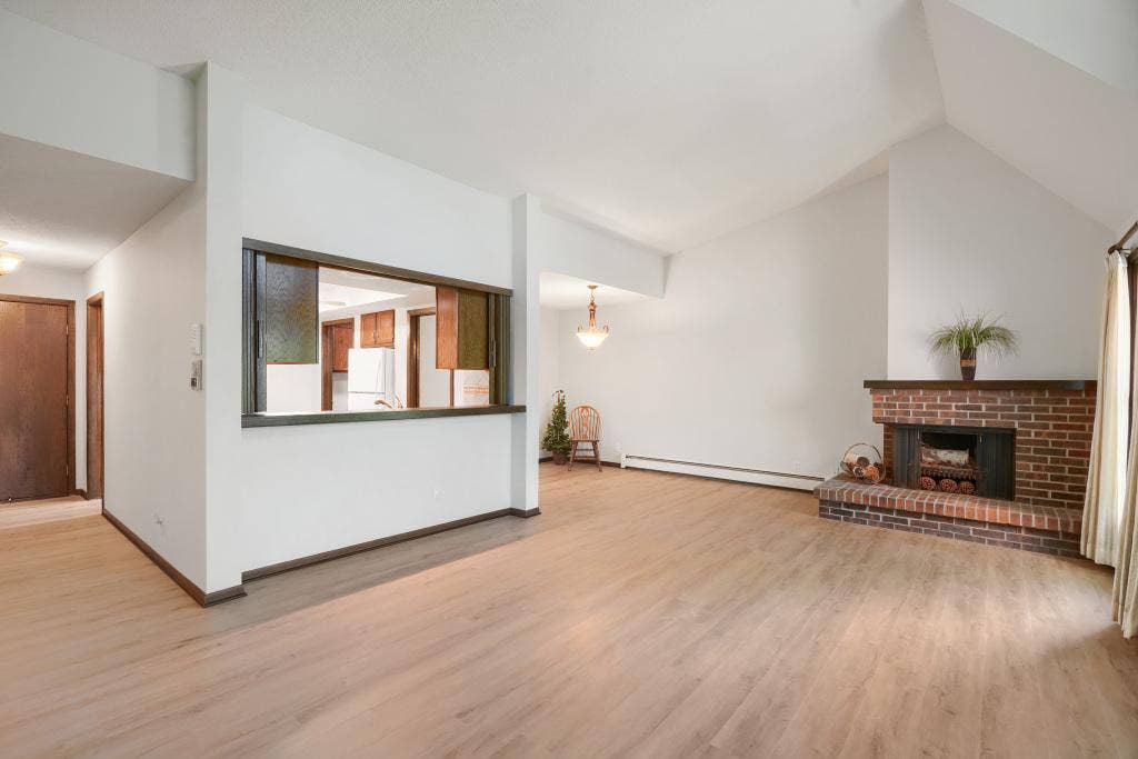 9600 Portland Avenue S, #317, Bloomington, MN 55420 Vaulted living room with counter seating into kitchen, spacious dining area and fireplace (never used by current owner)