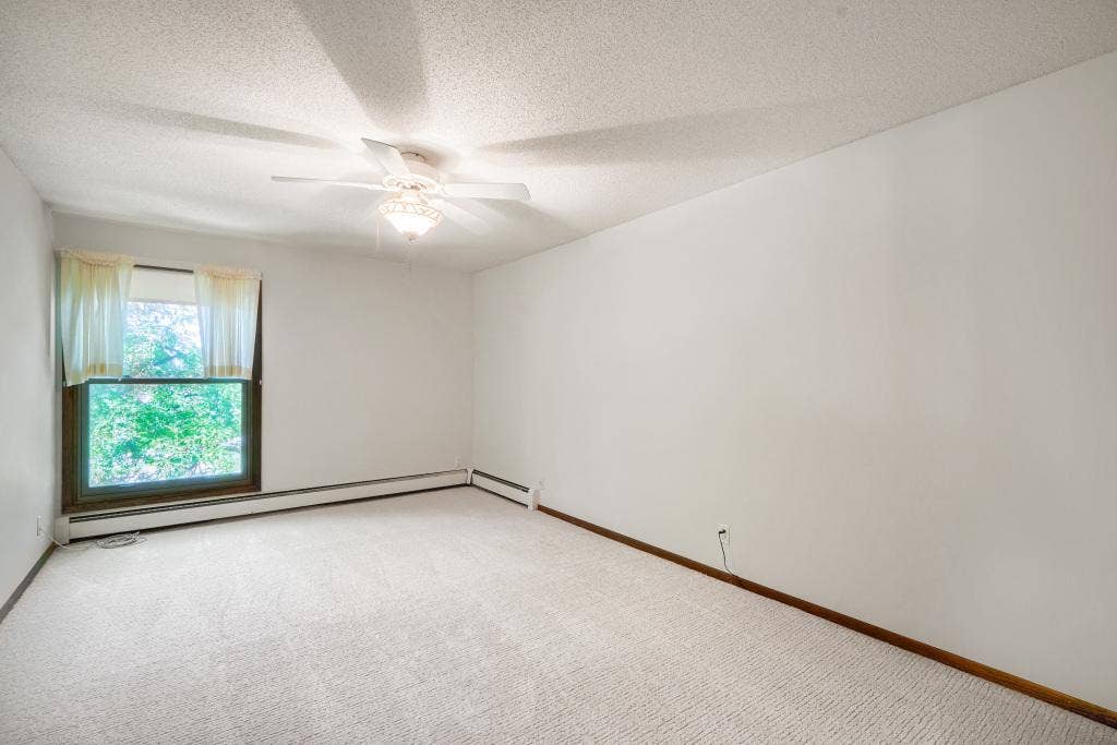 9600 Portland Avenue S, #317, Bloomington, MN 55420 Primary bedroom with new carpet and ceiling fan.