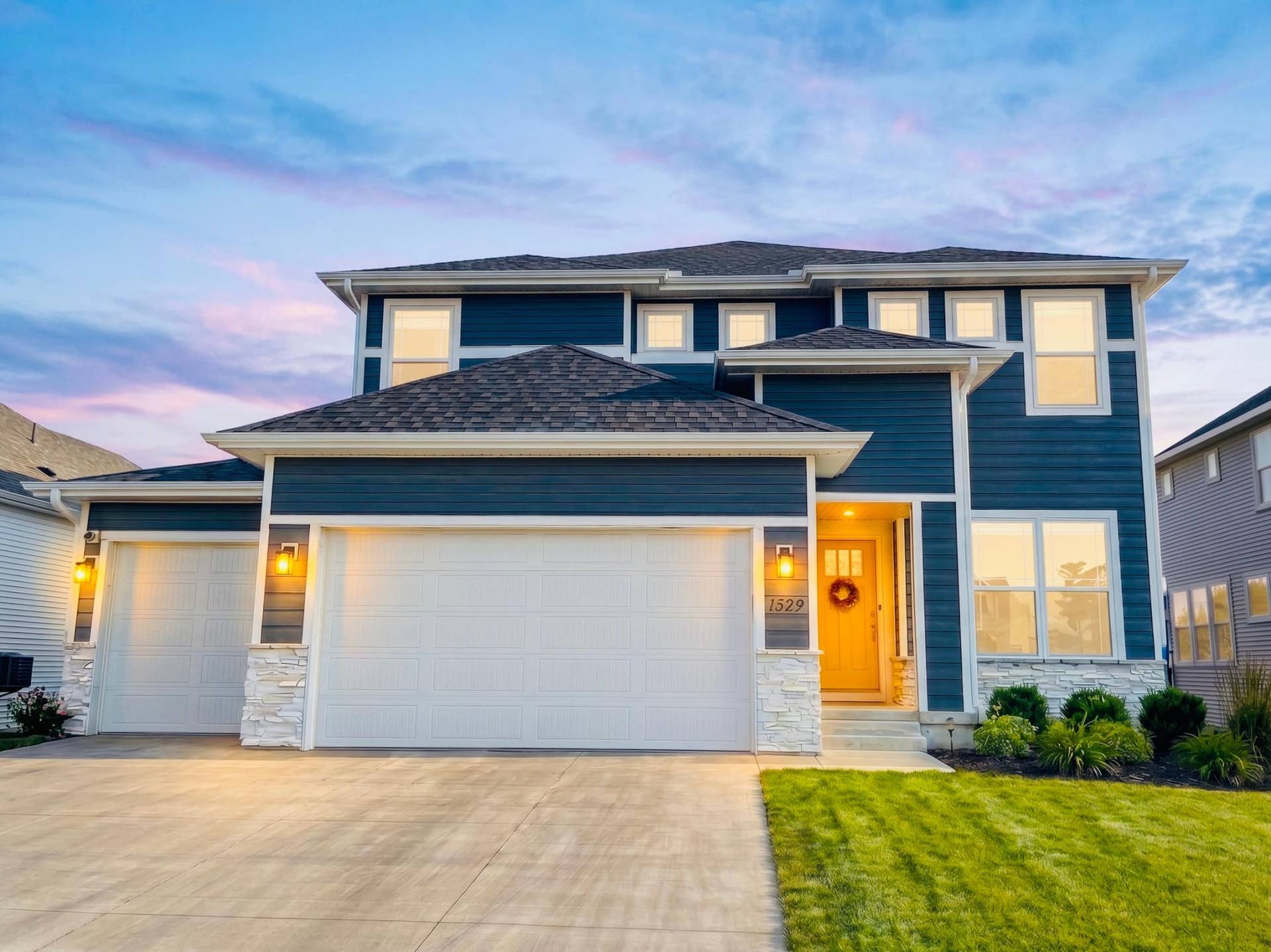 11549 Yuma Lane N, Maple Grove, MN 55369 Stunning two-story home showcasing modern curb appeal, a warm welcoming entry, and an expansive three-car garage
