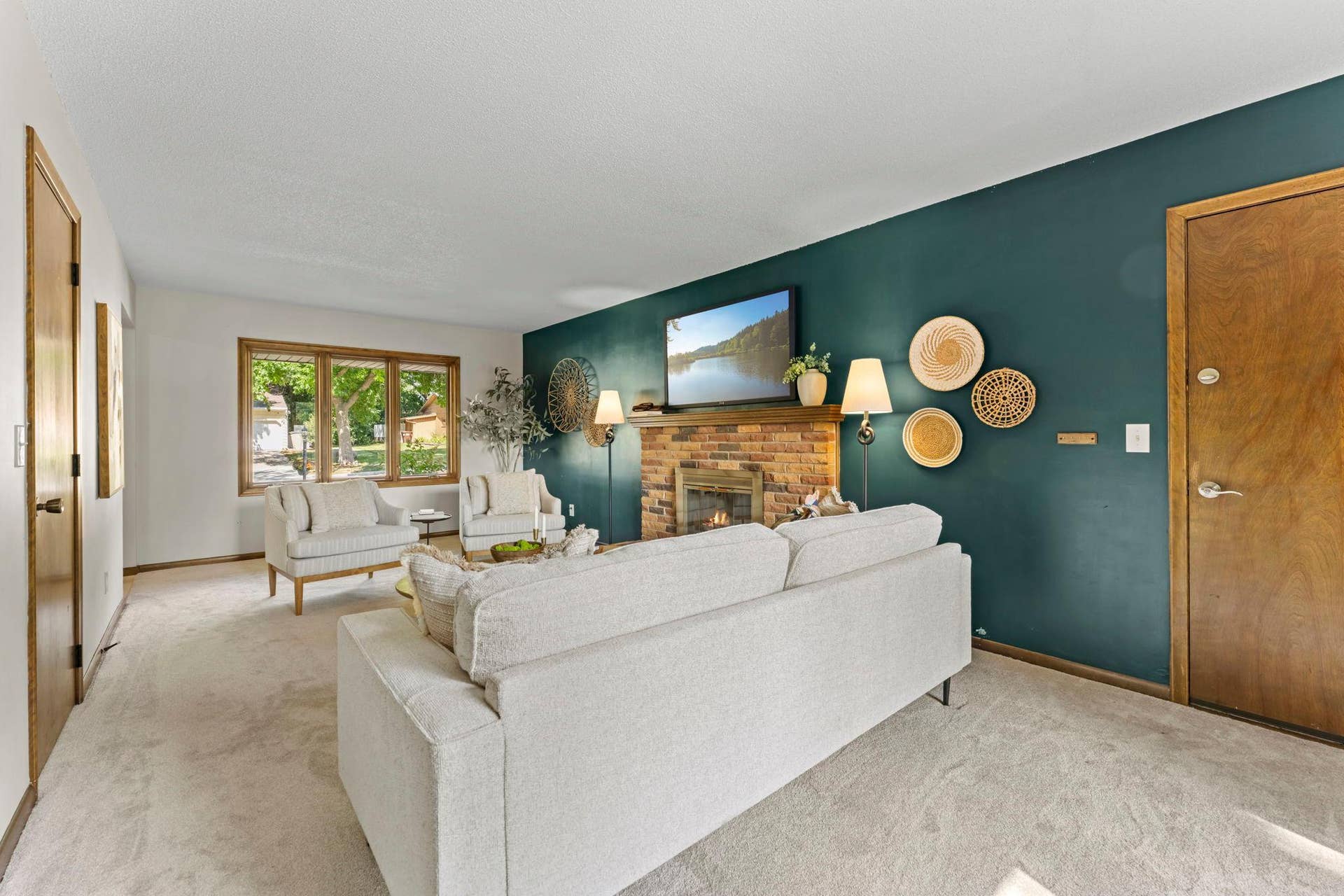 7181 Steepleview Road, Woodbury, MN 55125 Yet another room filled with natural light with a large window on one side, and a patio door on the other.