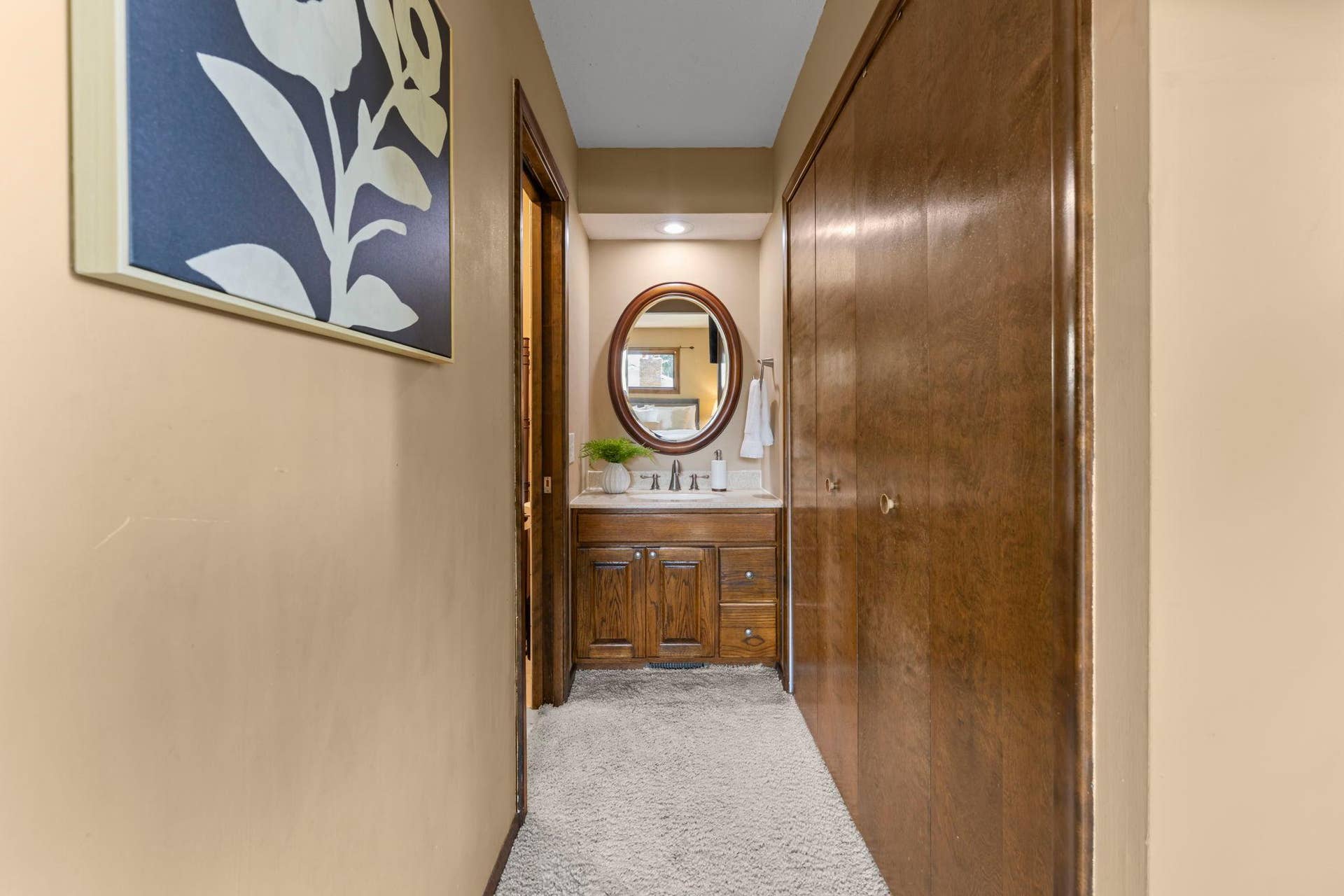 7181 Steepleview Road, Woodbury, MN 55125 The primary suite has a separated vanity layout with the shower and toilet privately enclosed, while the vanity and sink are conveniently located just outside.