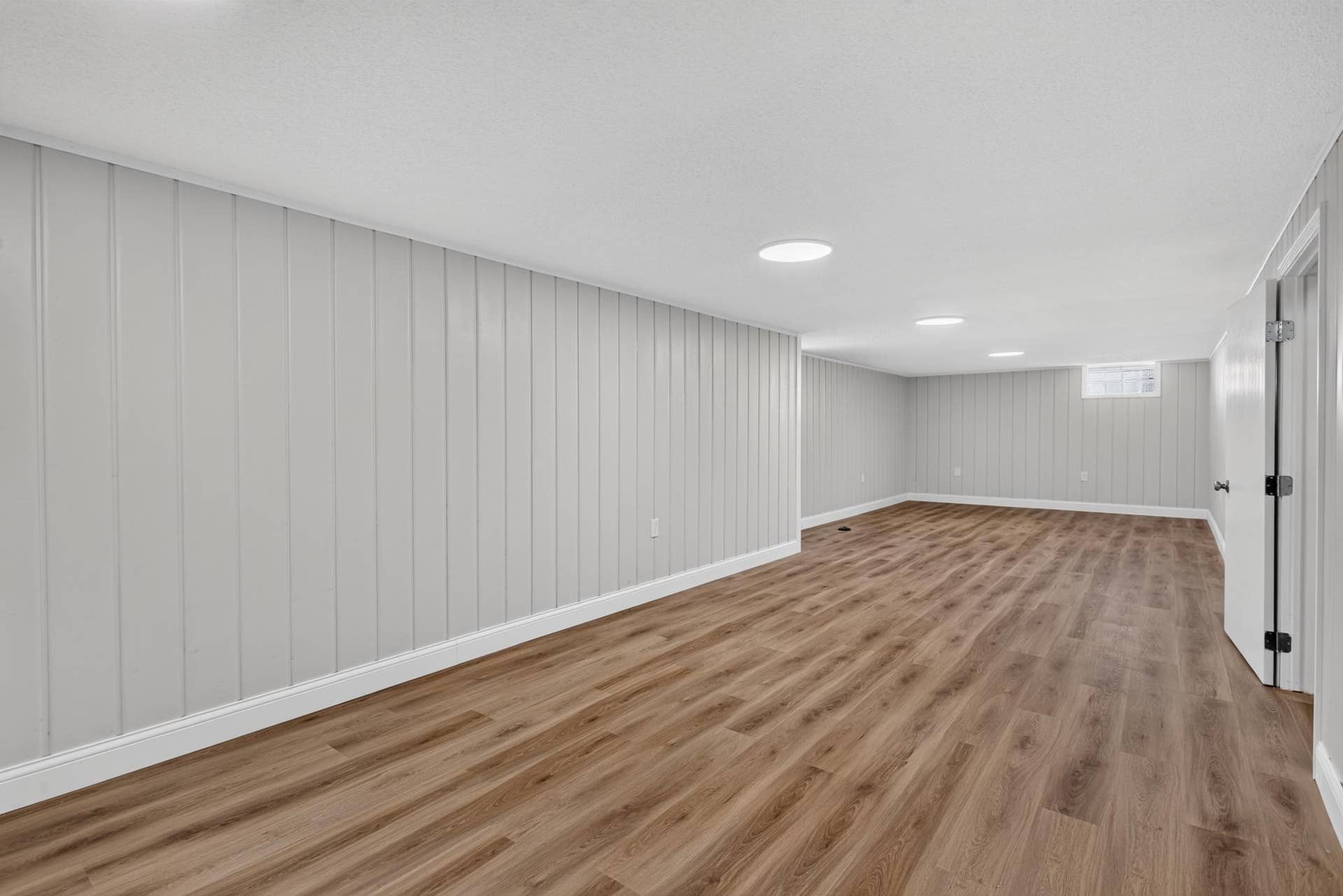 597 Meadow Lane, Woodbury, MN 55125 Large lower level family room with LVP flooring and fresh paint