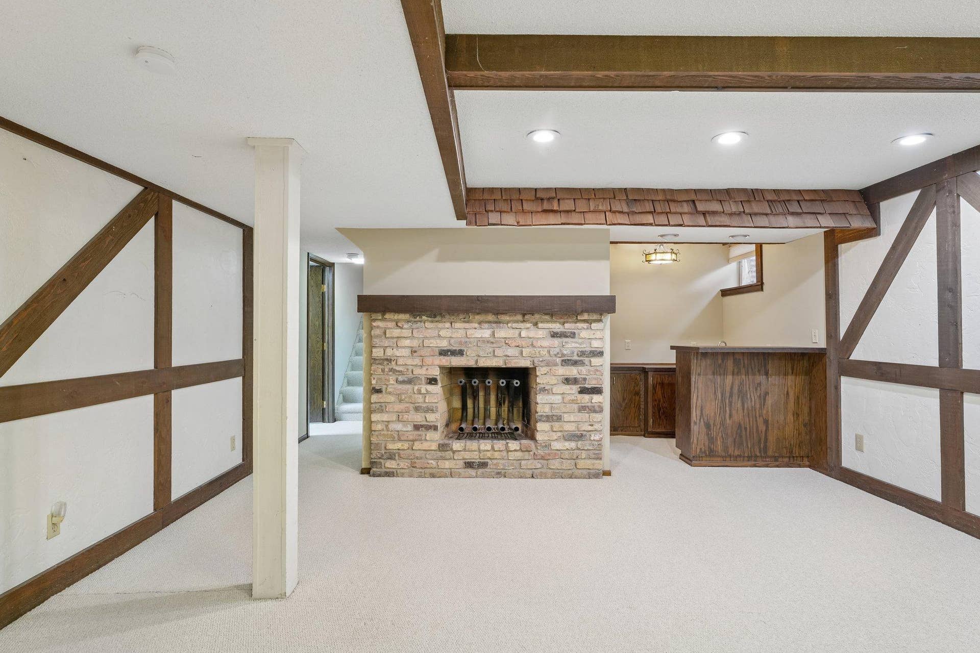 Lower level wood burning fireplace.