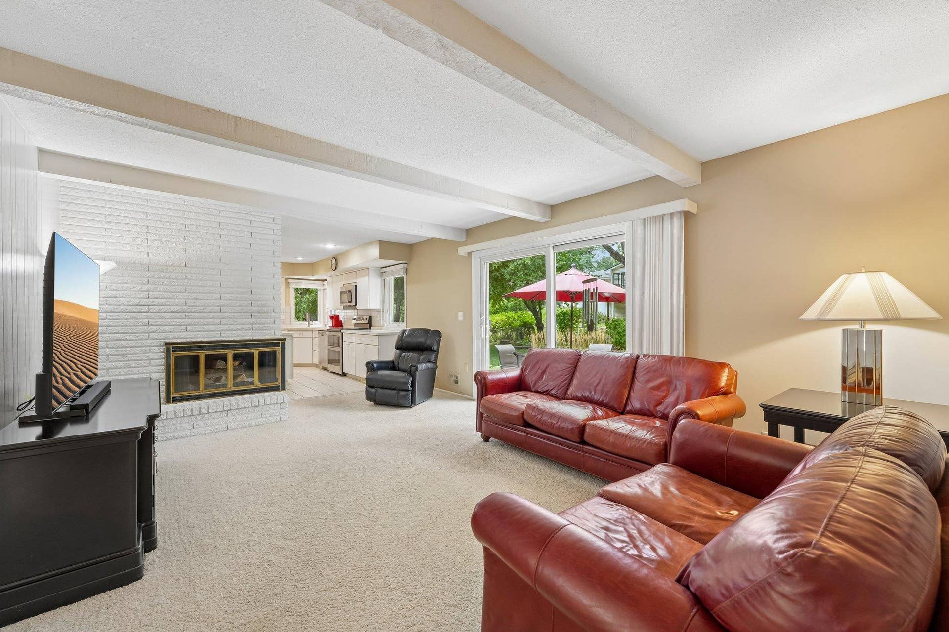 Main floor family room with 2 sided wood burning fireplace. Sliding door to the peaceful backyard patio