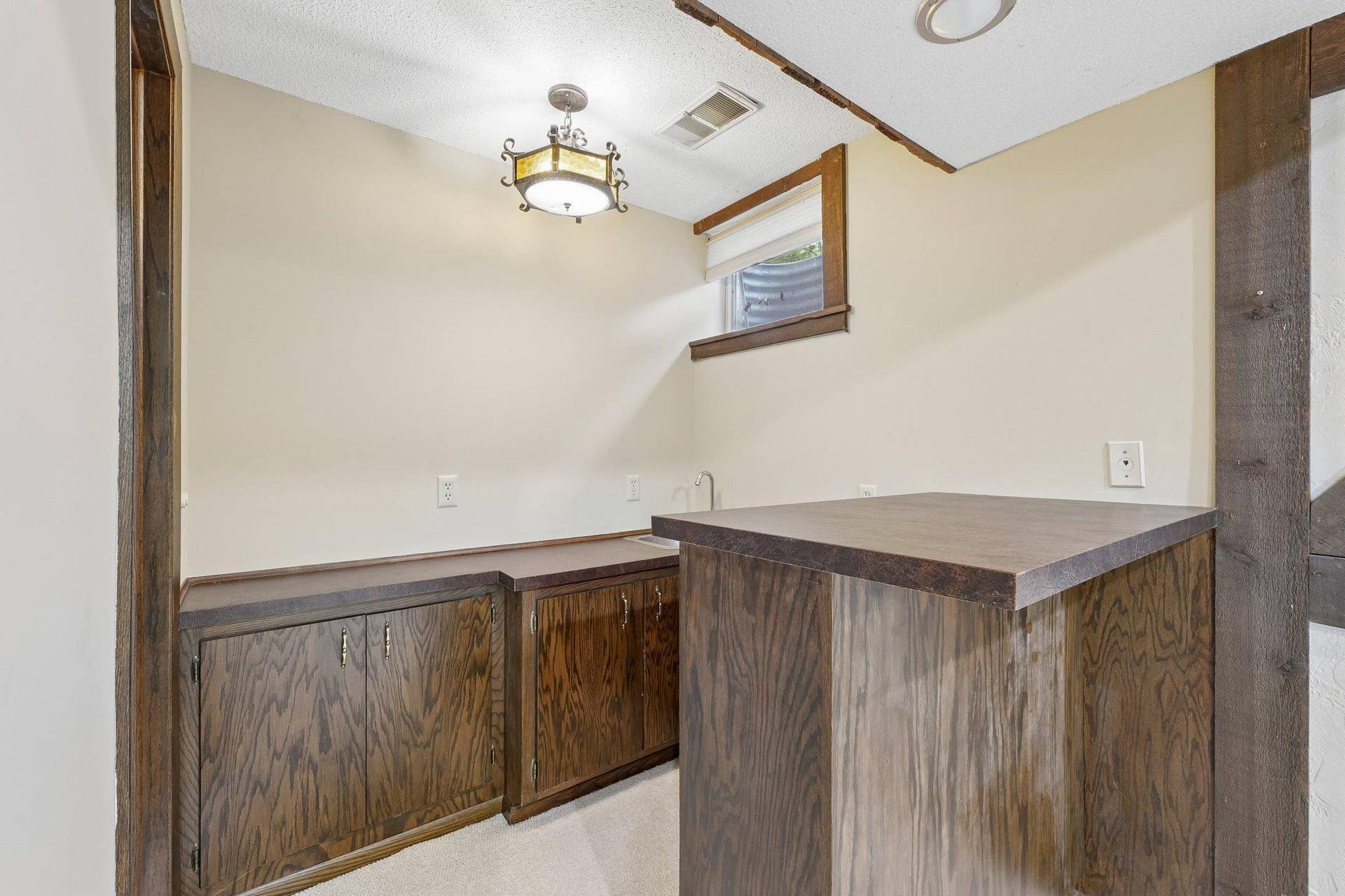 Lower level wet bar area with storage underneath