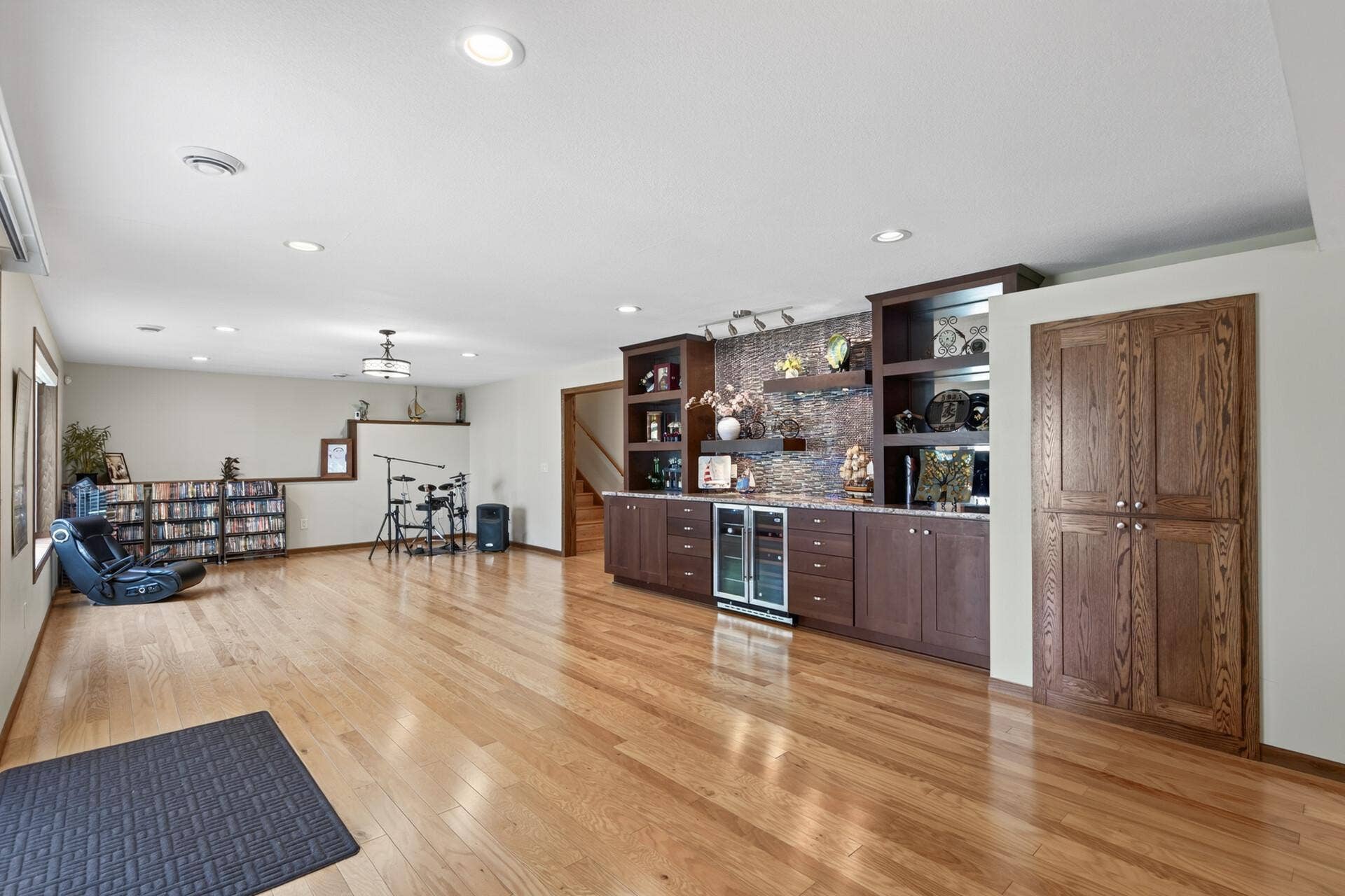 10548 Noble Circle N, Brooklyn Park, MN 55443 Basement Rec Room: Large finished recreation and entertainment room featuring a built-in bar with custom cabinetry, offering plenty of space to gather, relax, and entertain.