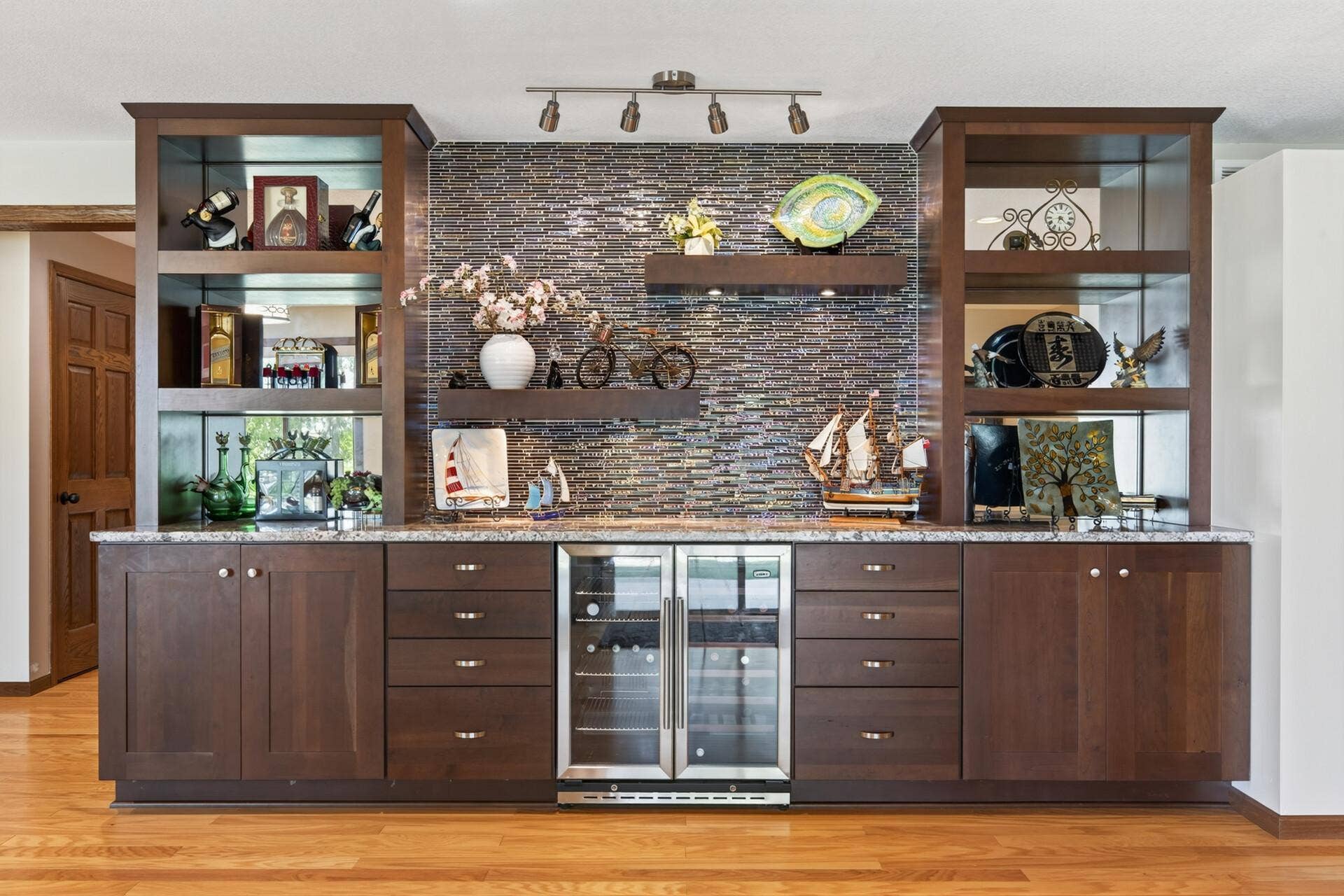 10548 Noble Circle N, Brooklyn Park, MN 55443 Basement Rec Room: Large finished recreation and entertainment room featuring a built-in bar with custom cabinetry, offering plenty of space to gather, relax, and entertain.