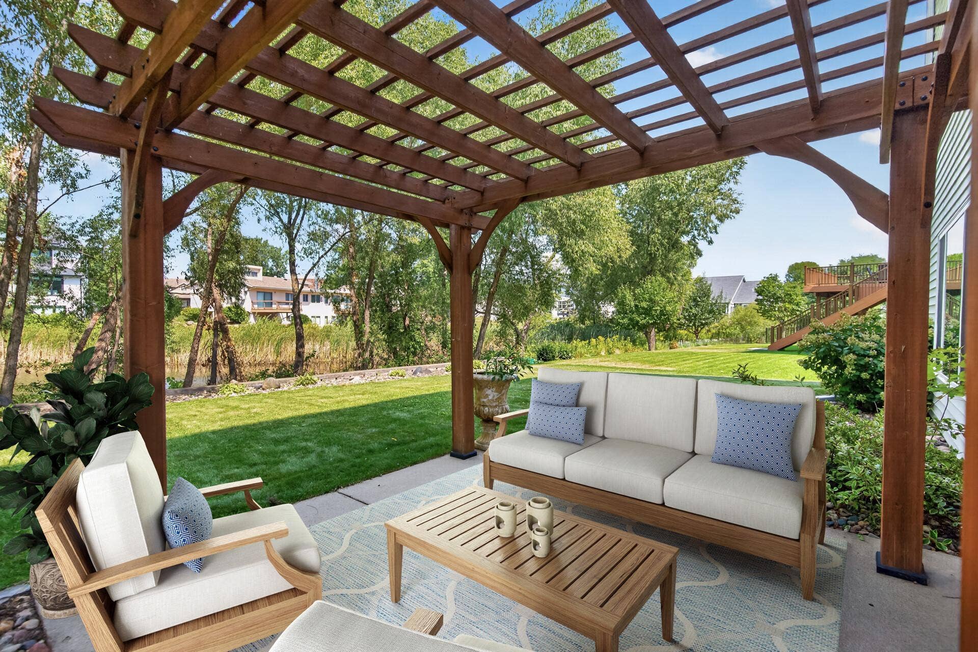 10548 Noble Circle N, Brooklyn Park, MN 55443 Patio: Spacious patio overlooking the pond, perfect for relaxing or entertaining.