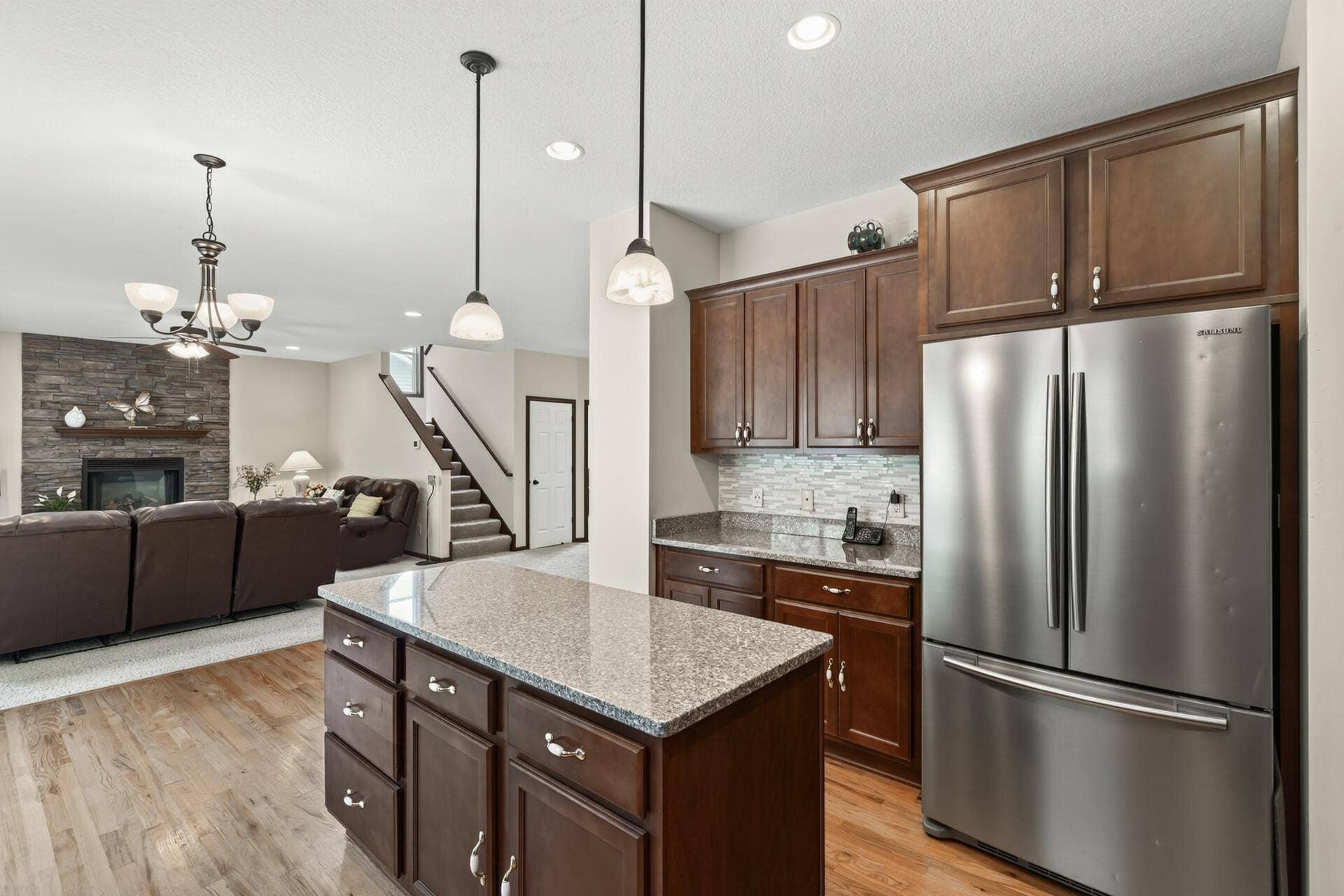 10548 Noble Circle N, Brooklyn Park, MN 55443 Kitchen: Beautiful kitchen featuring a spacious center island with granite countertops and ample cabinetry for storage.