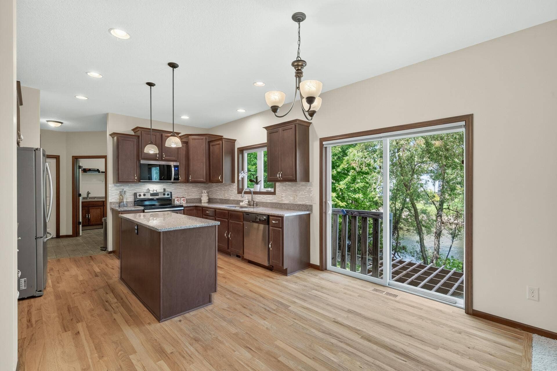 10548 Noble Circle N, Brooklyn Park, MN 55443 Kitchen: Beautiful kitchen featuring a spacious center island with granite countertops and ample cabinetry for storage.