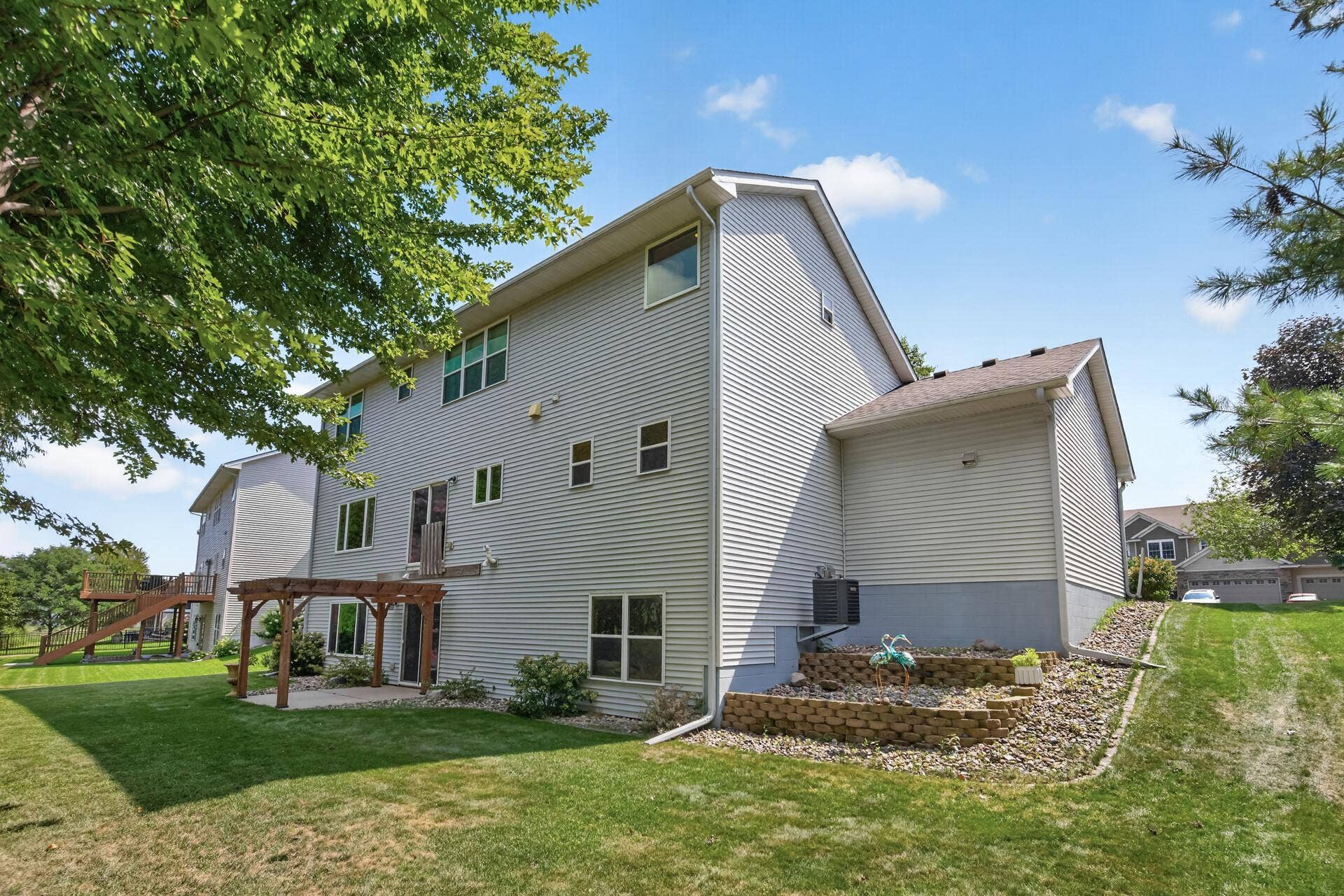 10548 Noble Circle N, Brooklyn Park, MN 55443 Backyard: Oversized backyard overlooking the pond, offering peaceful views and plenty of outdoor space.