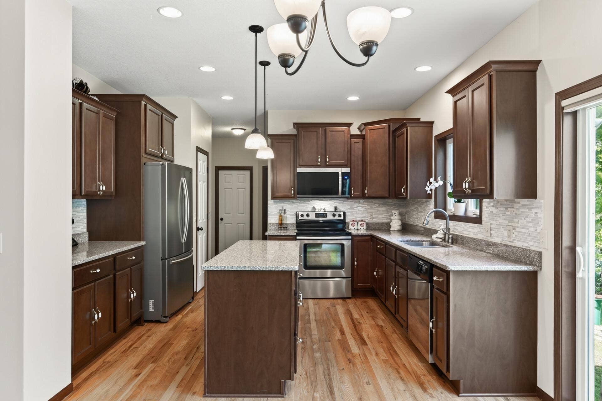 10548 Noble Circle N, Brooklyn Park, MN 55443 Kitchen: Beautiful kitchen featuring a spacious center island with granite countertops and ample cabinetry for storage.