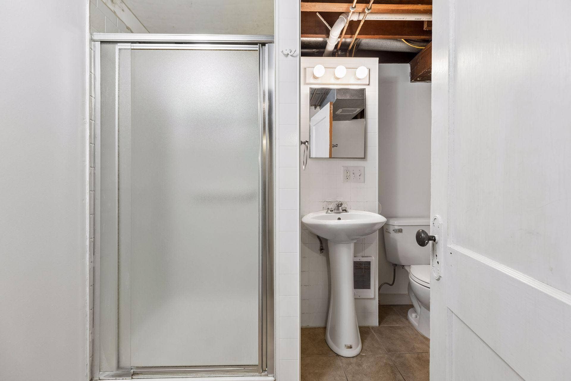 Second bathroom can be found just across from the basement bedroom..