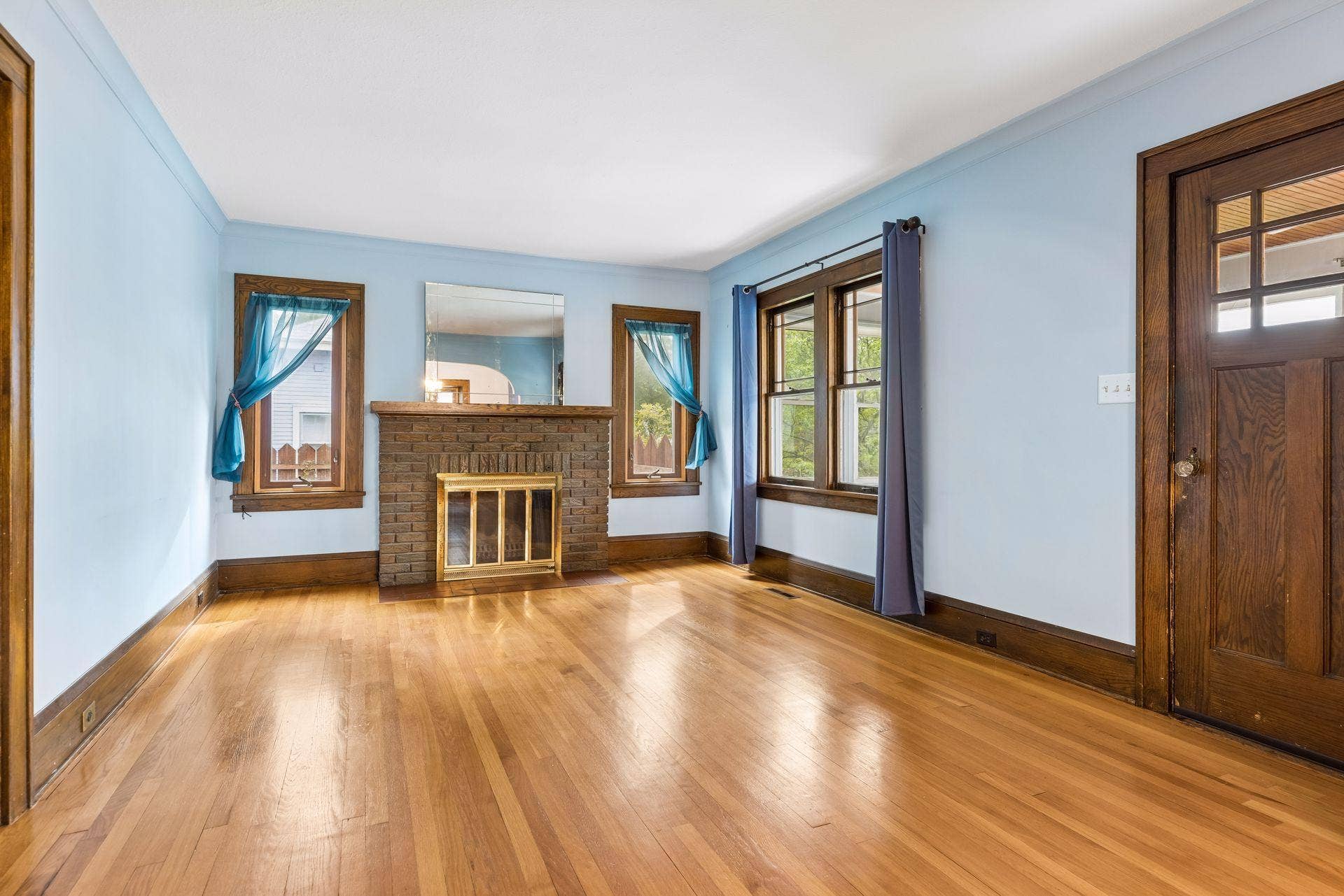 Living room features a brick fireplace and updated windows.