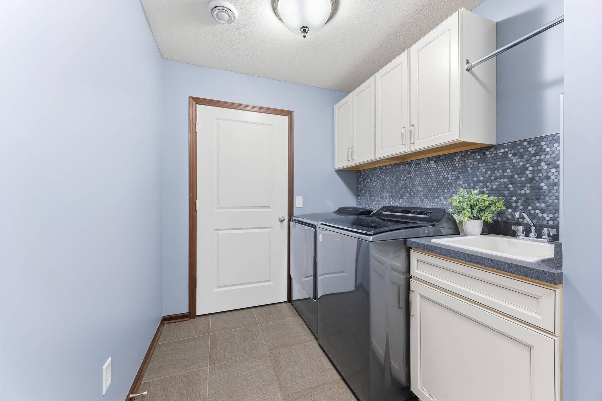 7417 Shadyview Lane N, Maple Grove, MN 55311 Convenient laundry room with high-end washer and dryer, utility sink, cabinetry and utility room access. You'll also find a pantry and coat/storage closet.