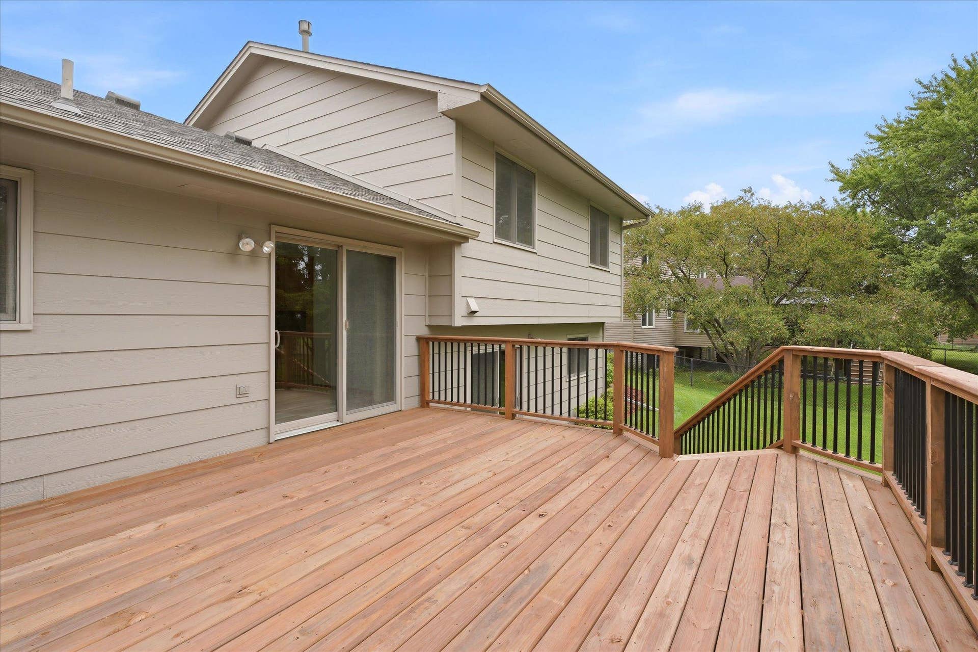 9225 Queens Gardens, Brooklyn Park, MN 55443 The combination of an upper-level cedar deck and lower-level patio provides multiple outdoor living spaces to enjoy.