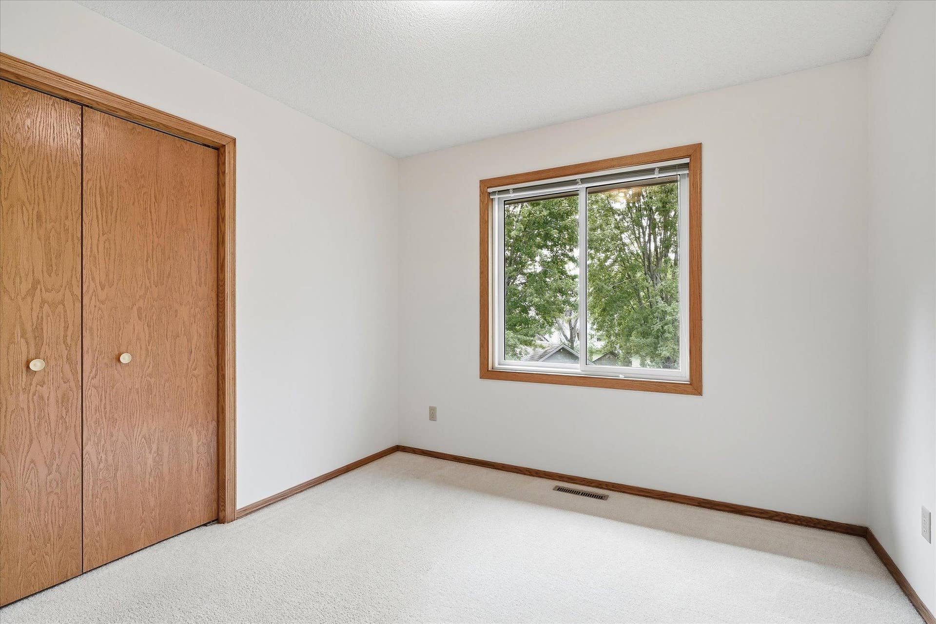 9225 Queens Gardens, Brooklyn Park, MN 55443 Another view of the second bedroom showcases its comfortable size and closet space.