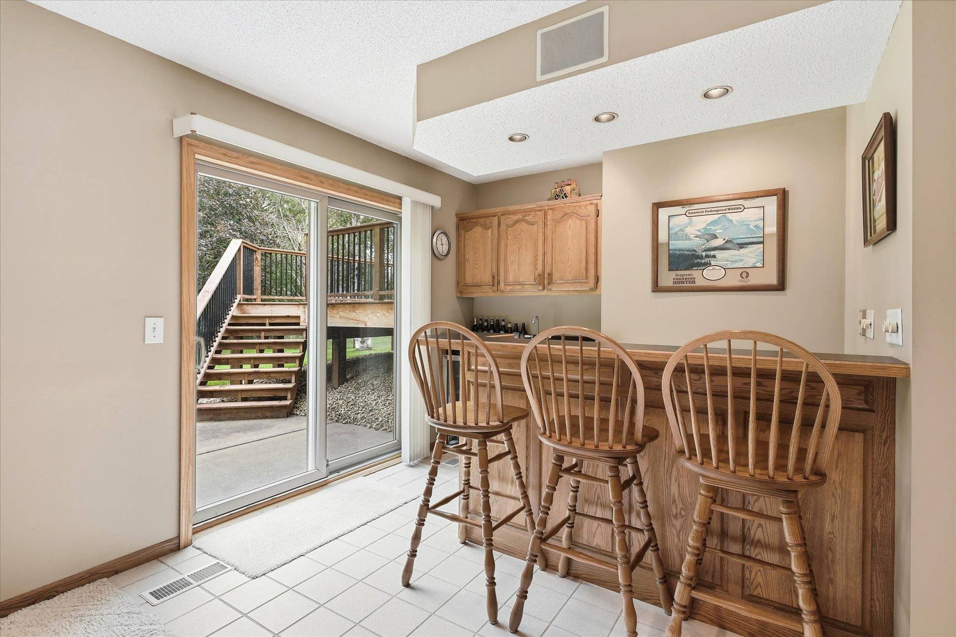 9225 Queens Gardens, Brooklyn Park, MN 55443 The wet bar adds a great entertaining feature to the lower level with cabinetry, counter space, and seating.