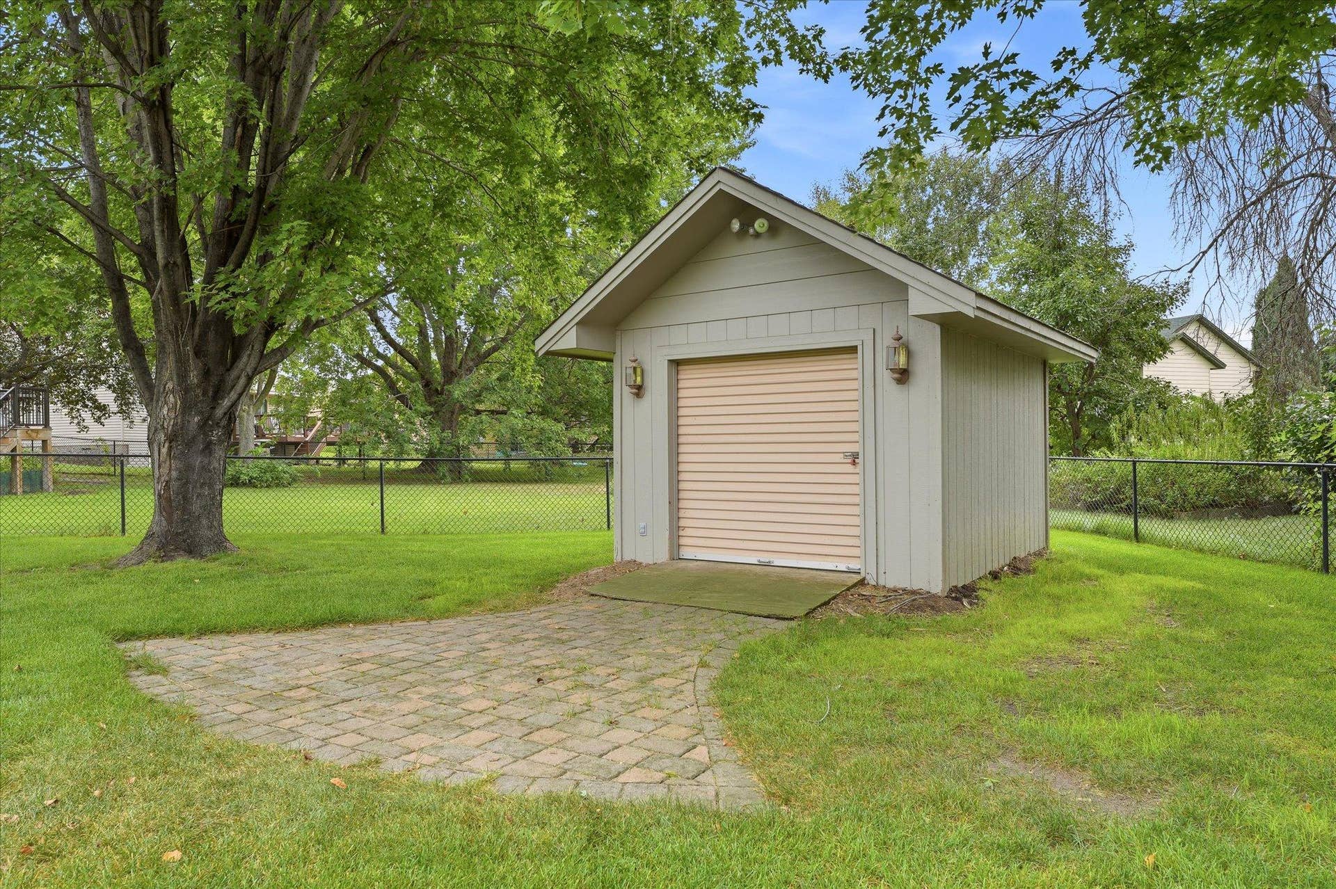 9225 Queens Gardens, Brooklyn Park, MN 55443 More than your average storage shed. This 12x10 bonus shed features electricity and a convenient roll-up door, making it easy to access larger lawn equipment and outdoor gear.