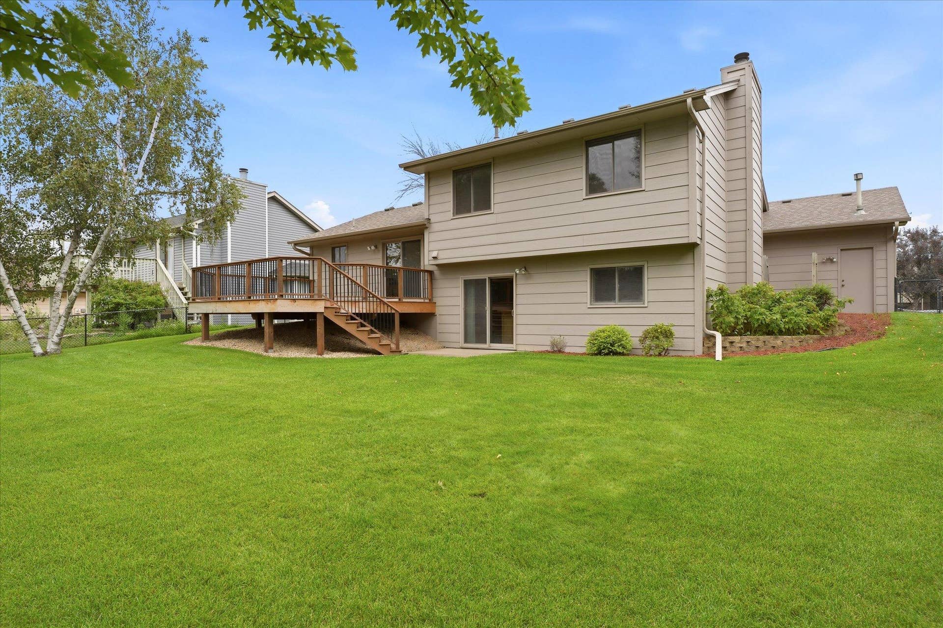 9225 Queens Gardens, Brooklyn Park, MN 55443 Fully fenced backyard offers plenty of usable lawn space along with multiple areas for relaxing, entertaining, and enjoying the outdoors.