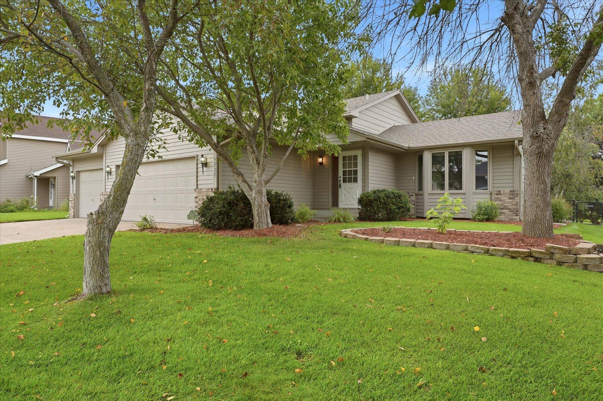 9225 Queens Gardens, Brooklyn Park, MN 55443 Thoughtfully maintained exterior surrounded by professional landscaping, with an irrigation system helping keep the lawn and landscaping looking their best throughout the season.