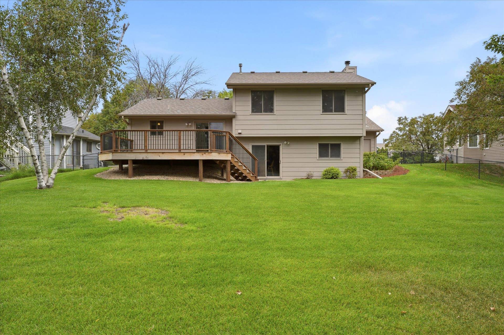 9225 Queens Gardens, Brooklyn Park, MN 55443 Spacious backyard is enhanced by professional landscaping and an irrigation system to help keep the lawn and landscaping looking their best.